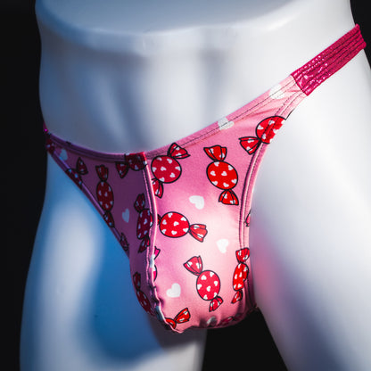 Men's Valentine Days candies with pink metallic straps thong underwear, classic cut, angled front view.