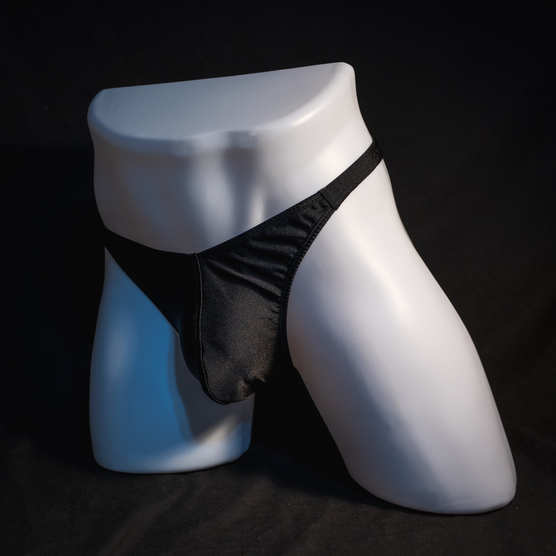 Men's solid black spandex thong underwear. classic cut, angled full front view.
