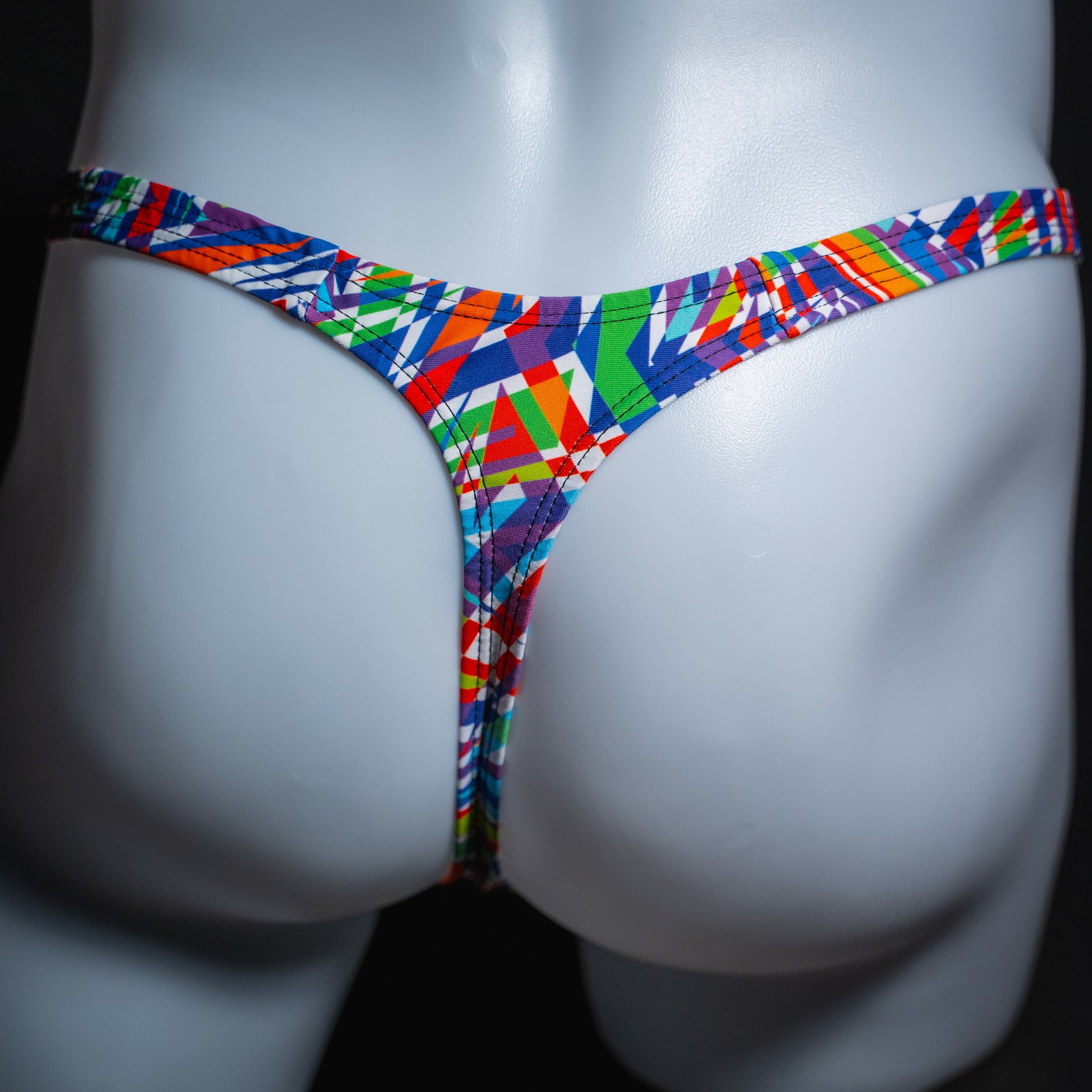 Men's bold colorful thong underwear, classic cut, rear view.