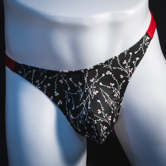 Men's black and white floral thong underwear, classic cut, front view.