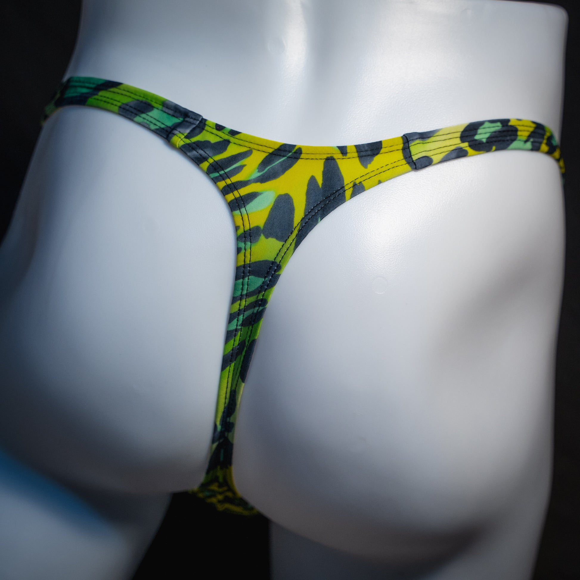 Men's green leopard print thong underwear, slim cut, rear view.