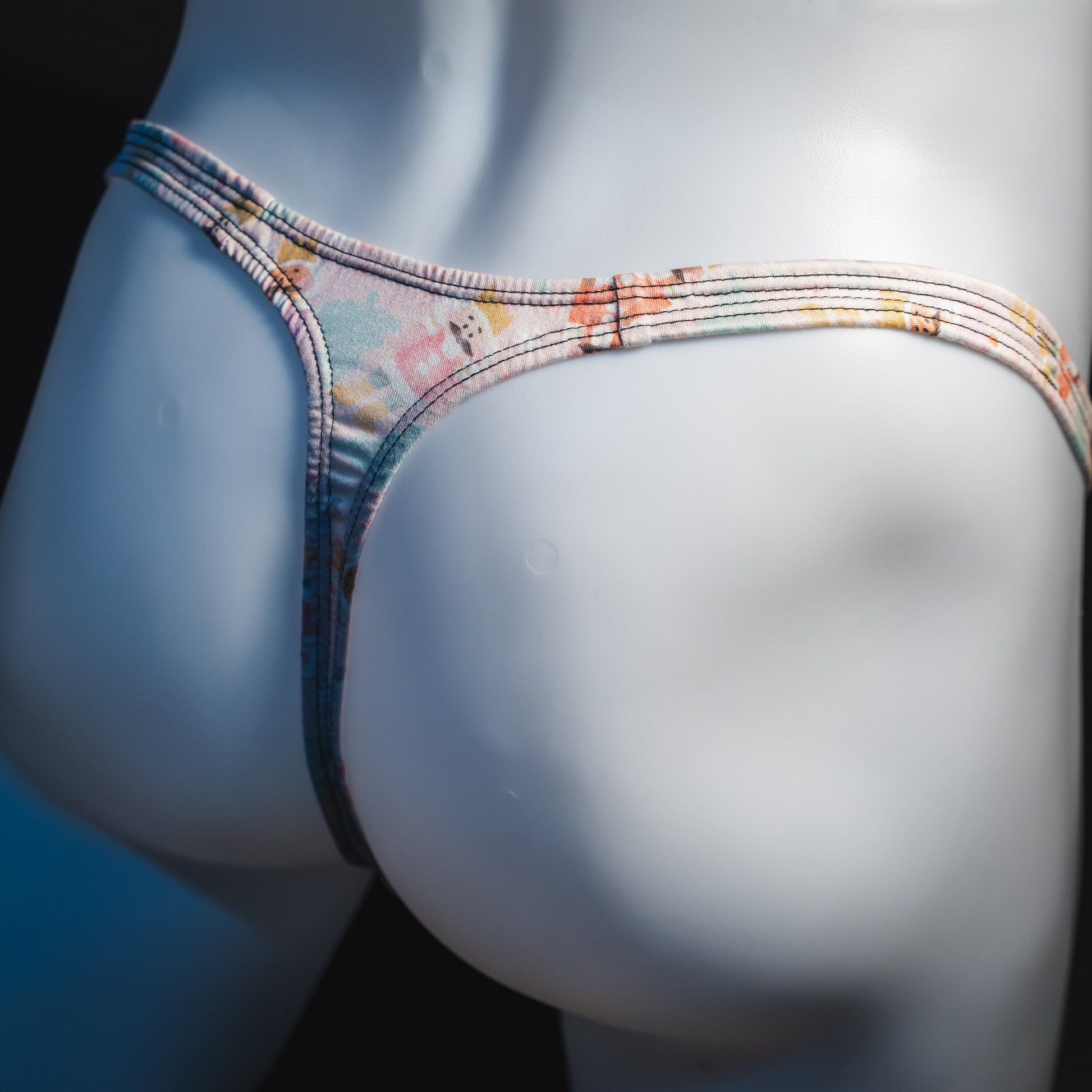 Men's nutcracker thong underwear, classic cut, angled rear view.