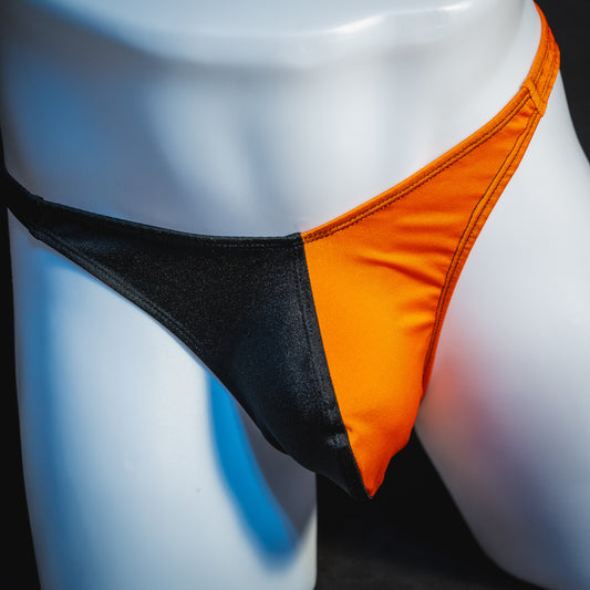 Men's orange and black asymmetrical Halloween thong, classic cut, front view.