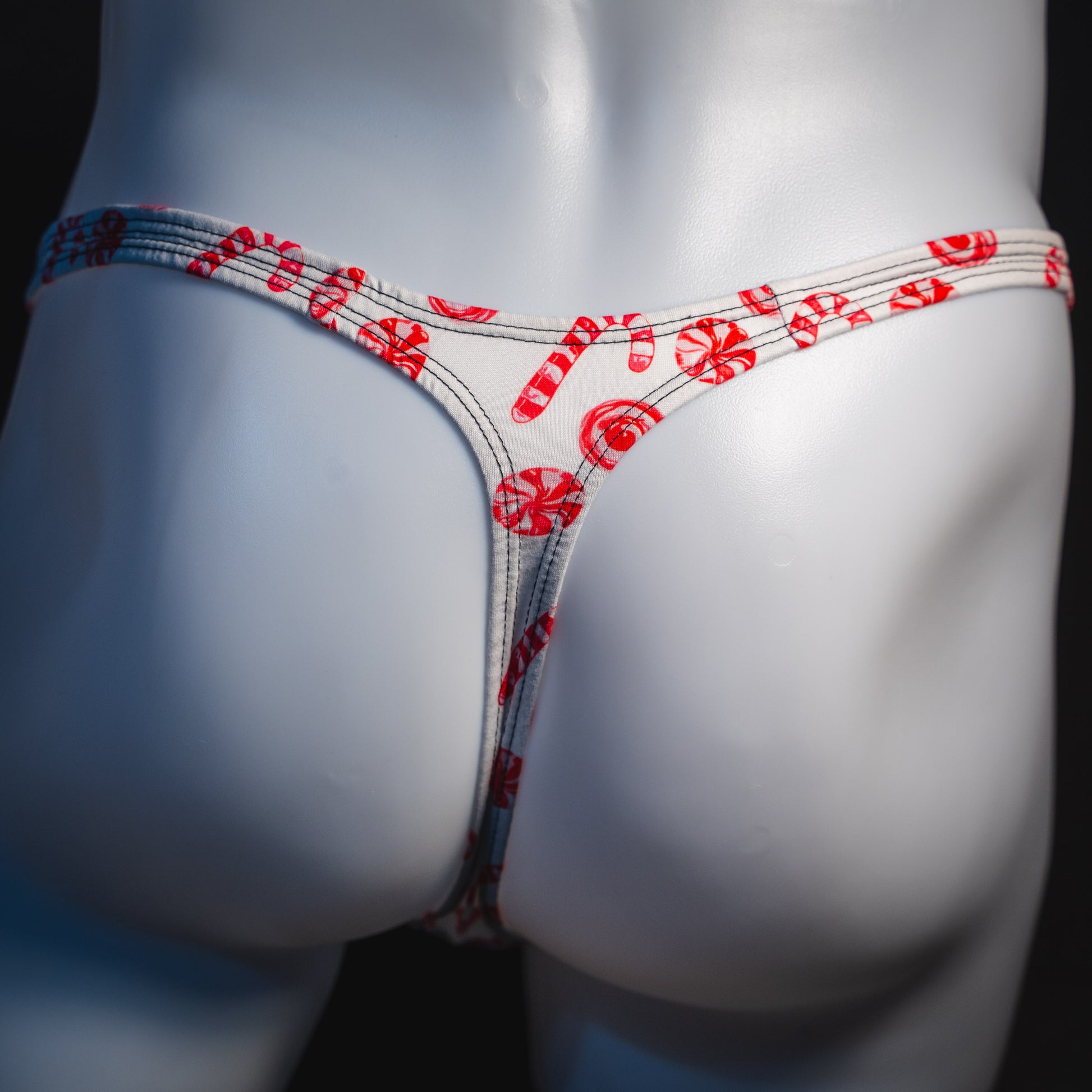 Men's peppermint candies Christmas thong underwear, classic cut, rear view.