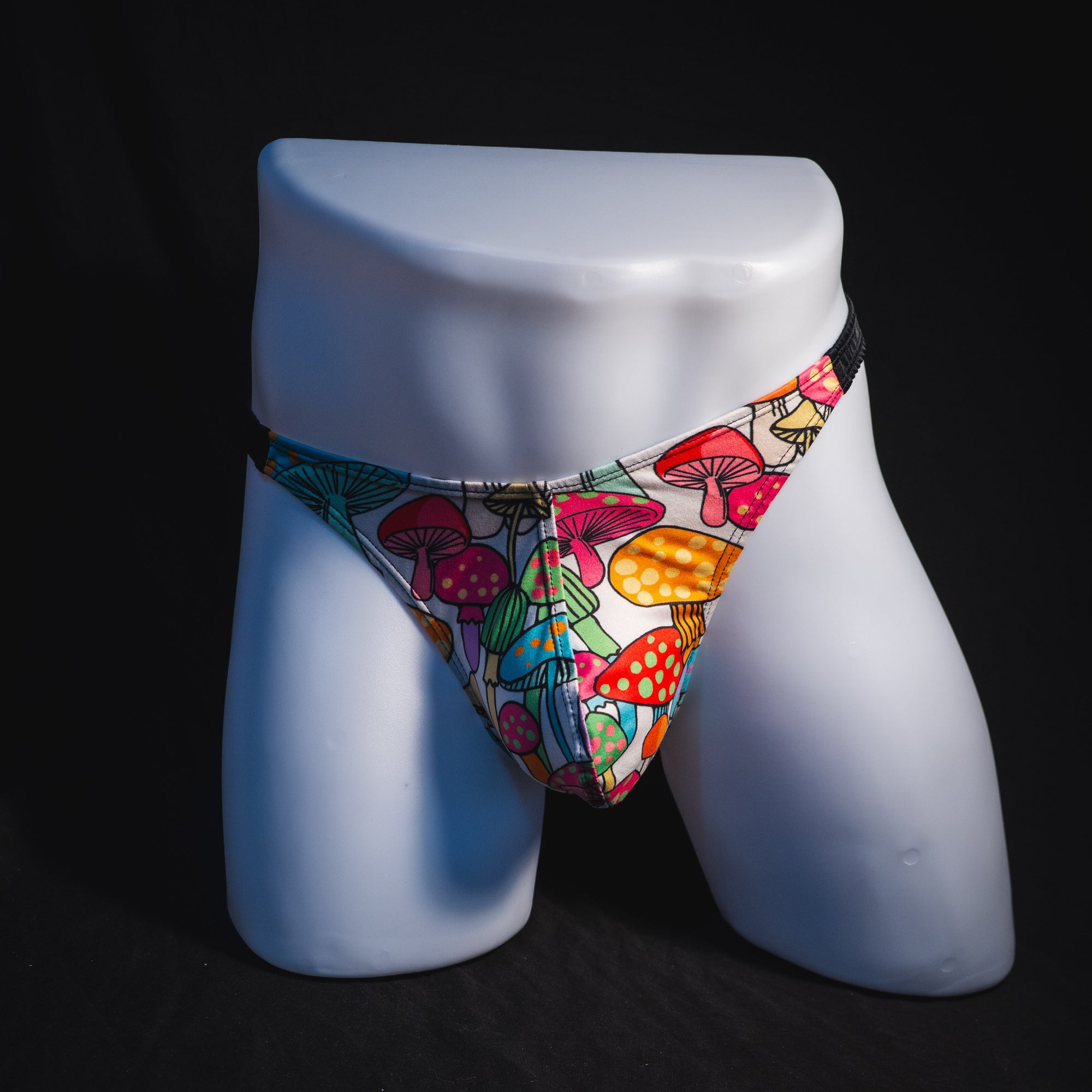 Men's colorful mushroom thong underwear, classic cut, full front view.