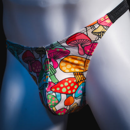 Men's colorful mushroom thong underwear, classic cut, angled front view.