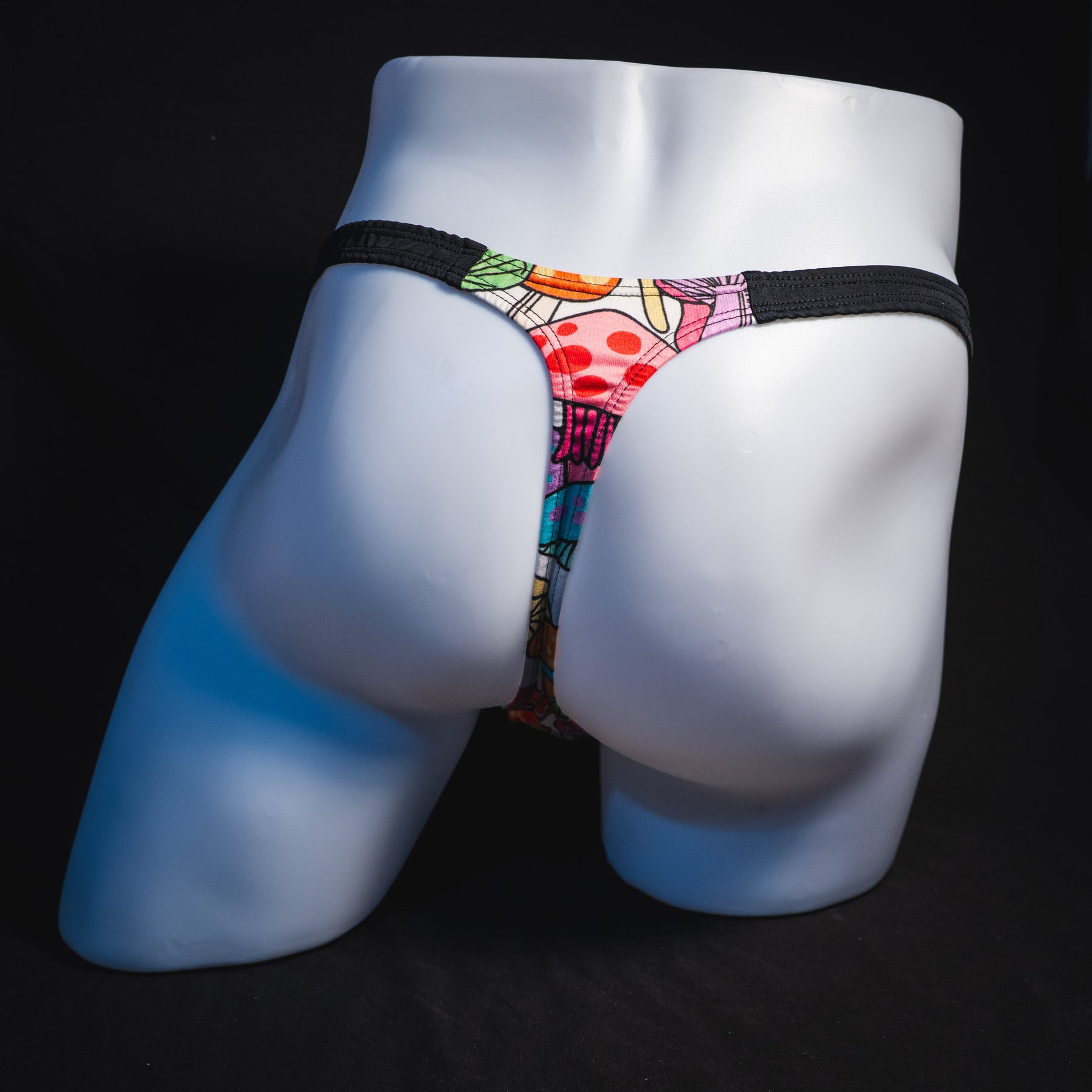 Men's colorful mushroom thong underwear, classic cut, full rear view.