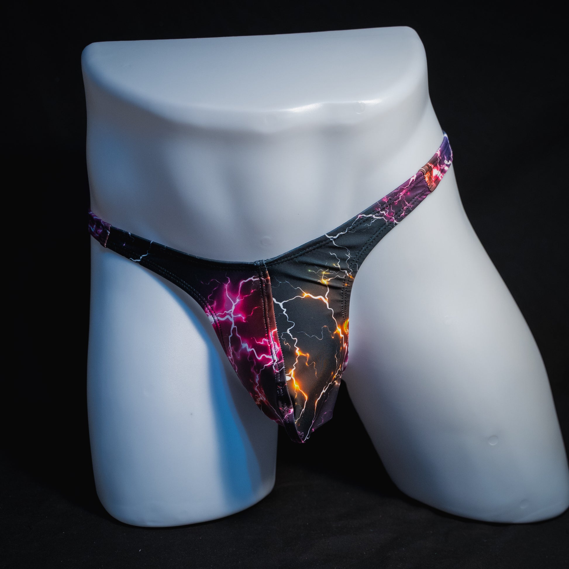 Men's purple lightning thong underwear, slim cut, full front view.