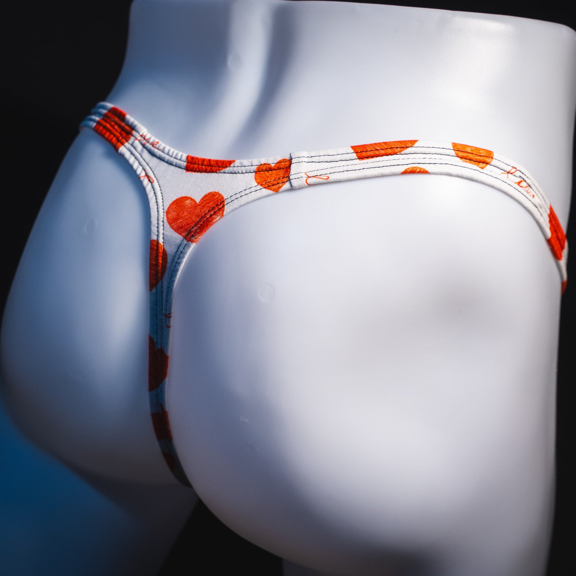 Men's red hearts Valentine's Day thong underwear, Classic cut, angled rear view.