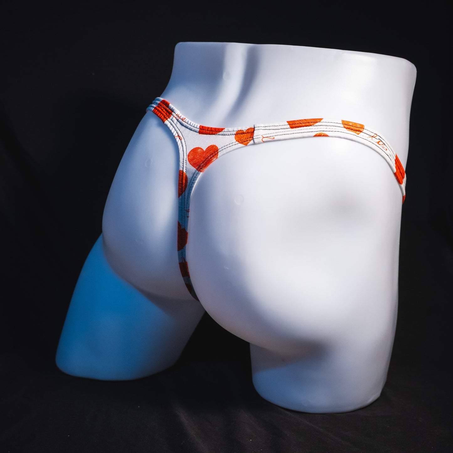 Men's red hearts Valentine's Day thong underwear, Classic cut, full angled rear view.