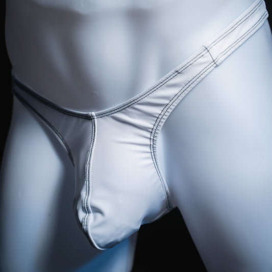 Men's solid white thong, slim cut, angled front view.
