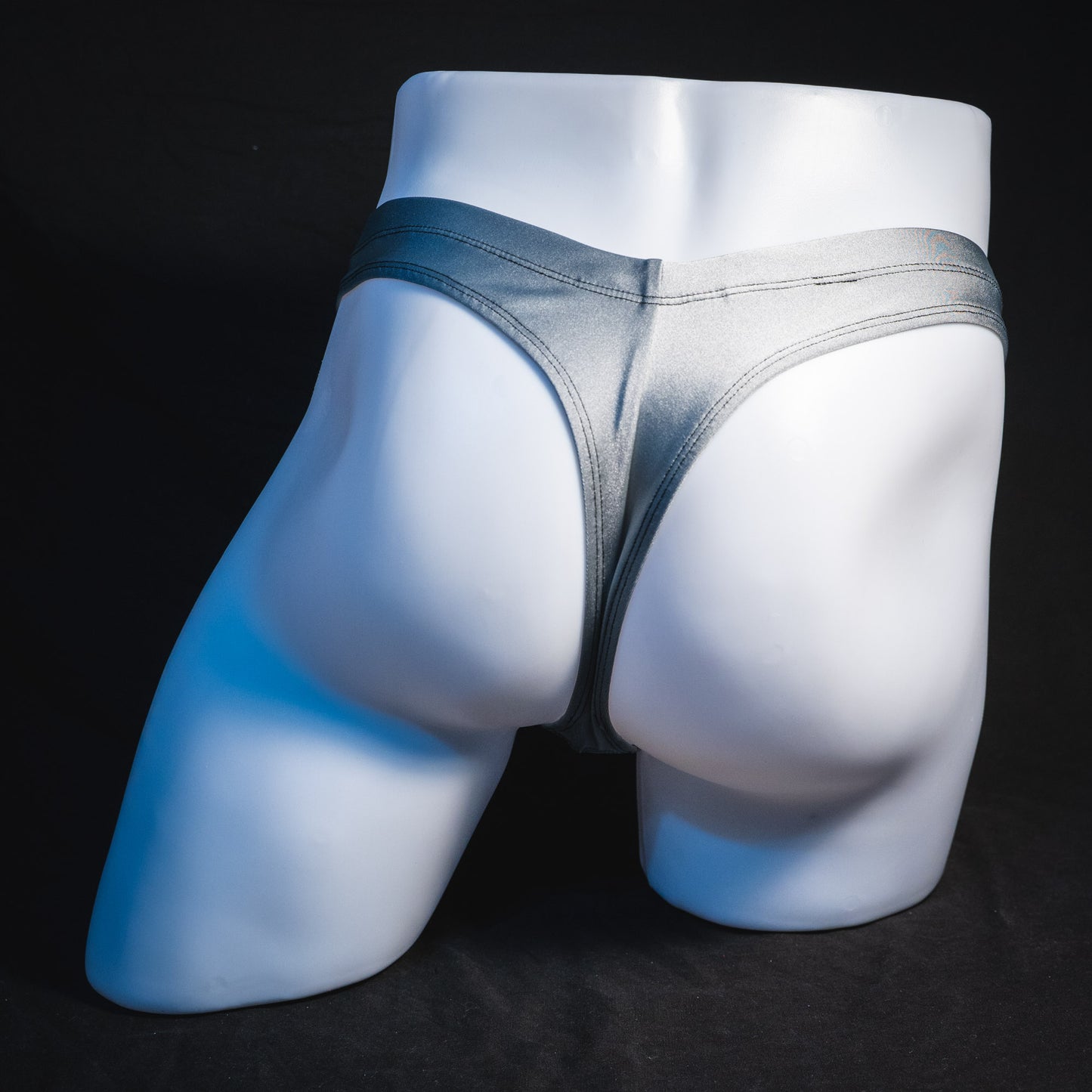 Men's silver with black mesh panels thong underwear, contour cut, full rear view.