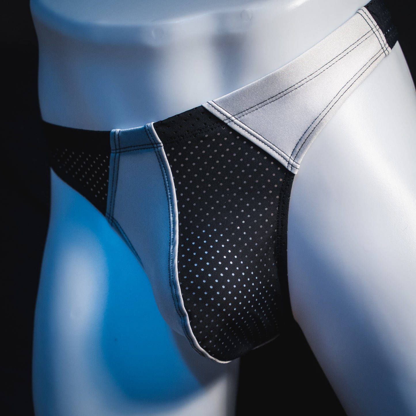Men's black and white mesh thong underwear, contour cut, front angled view