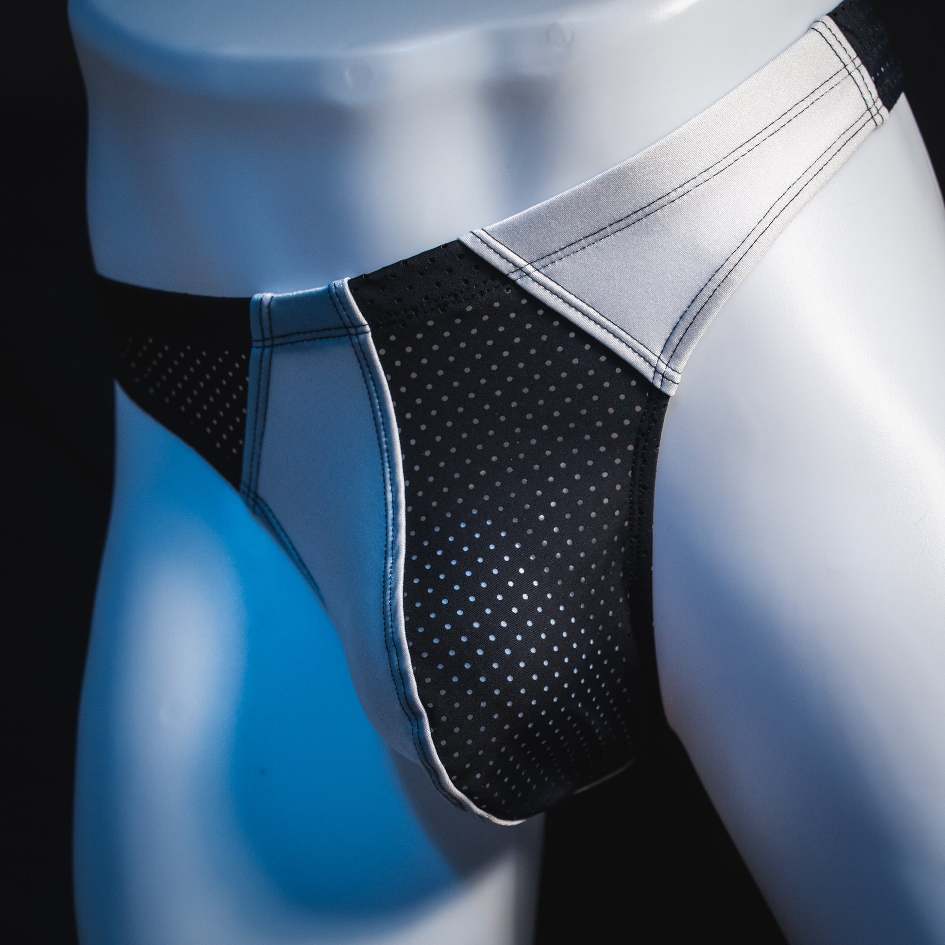 Men's black and white mesh thong underwear, contour cut, front angled view
