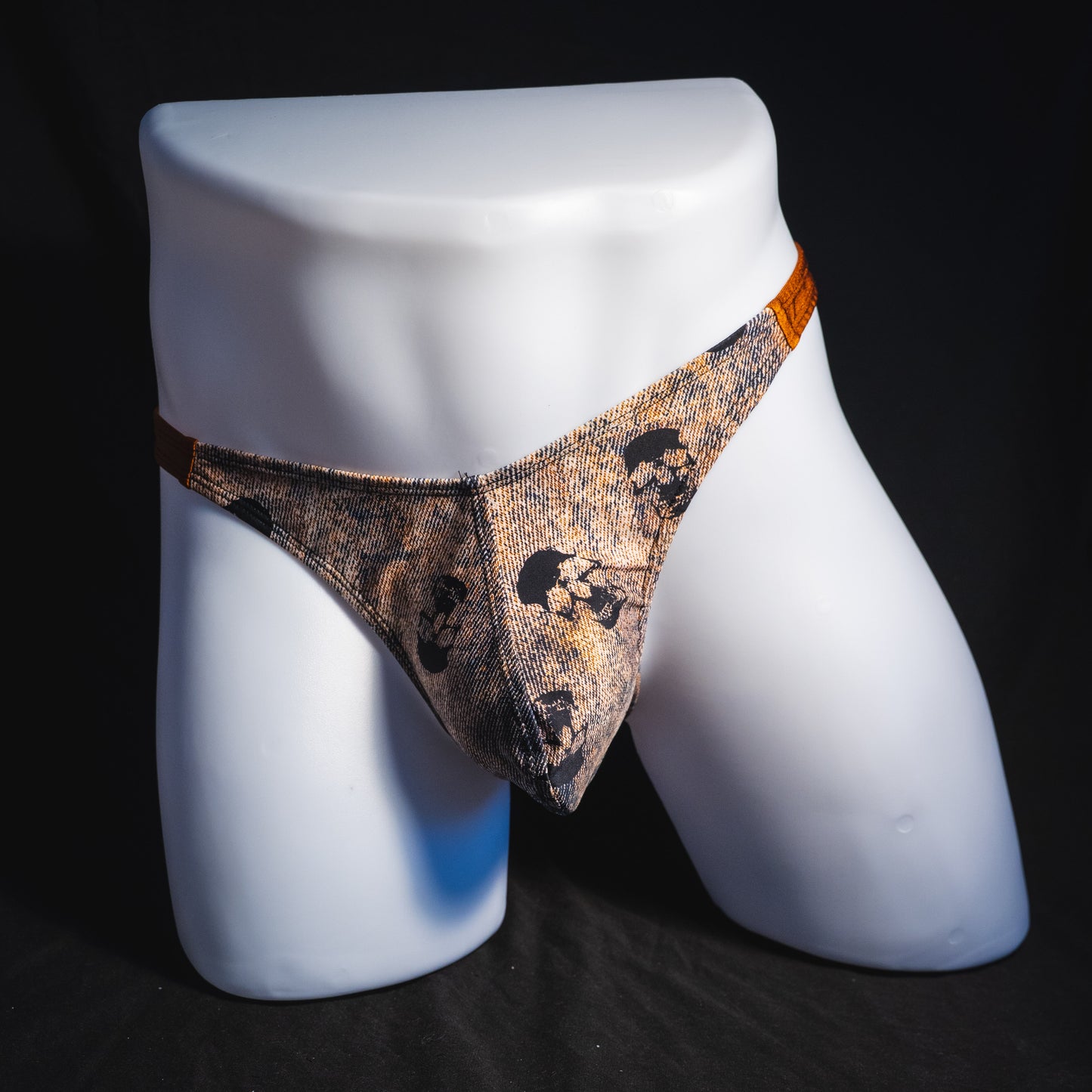 Men's black skulls on brown thong underwear, Classic cut, full front view.