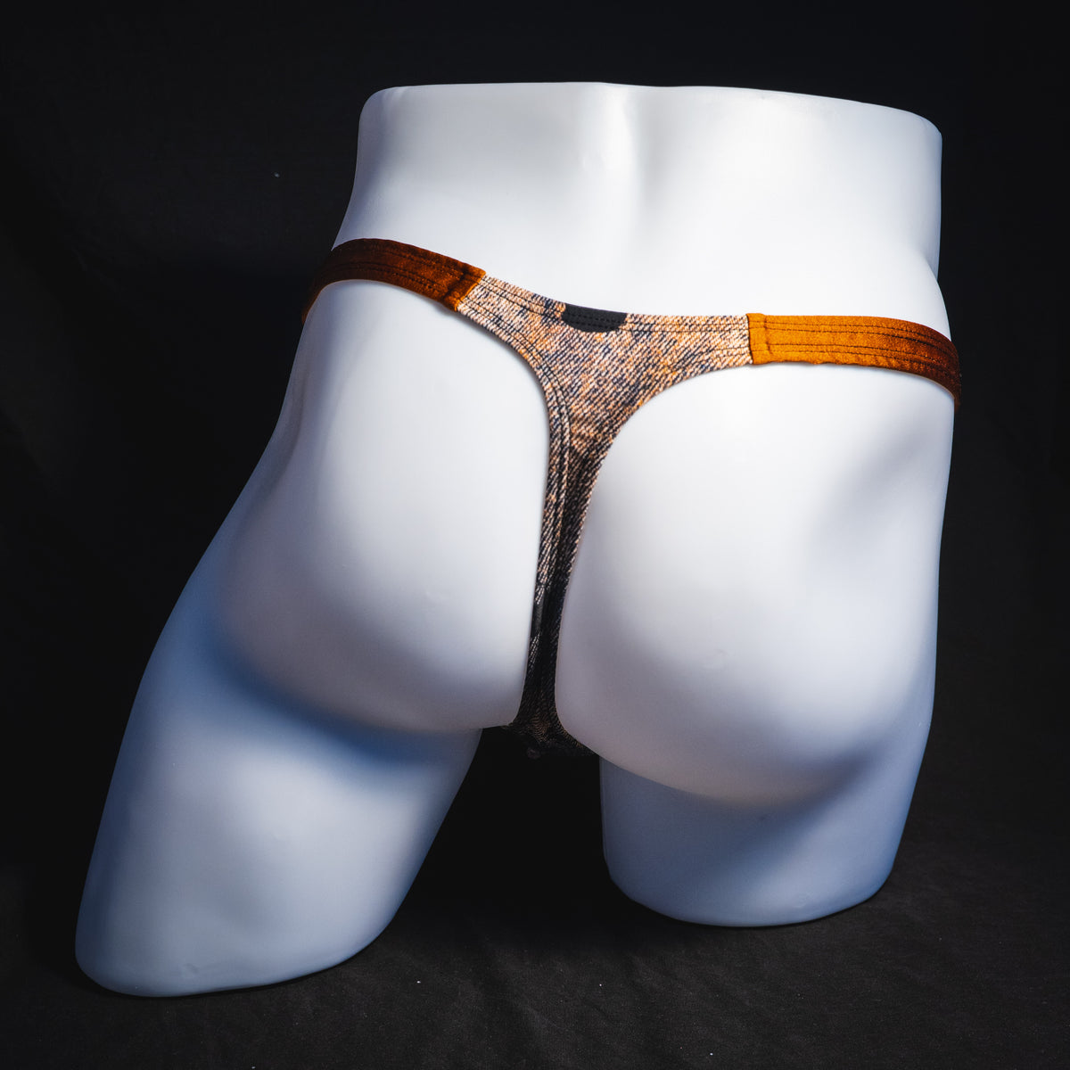 Men's black skulls on brown thong underwear, Classic cut, full rear view.