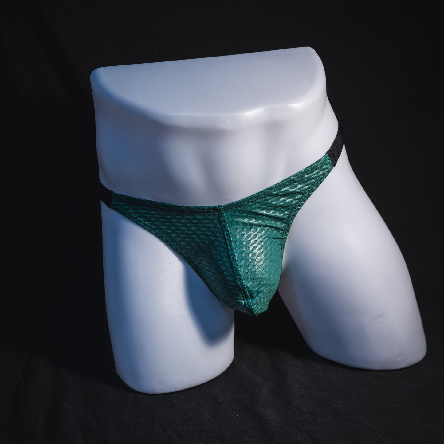 Men's green and black mesh thong underwear, classic cut, full front view.