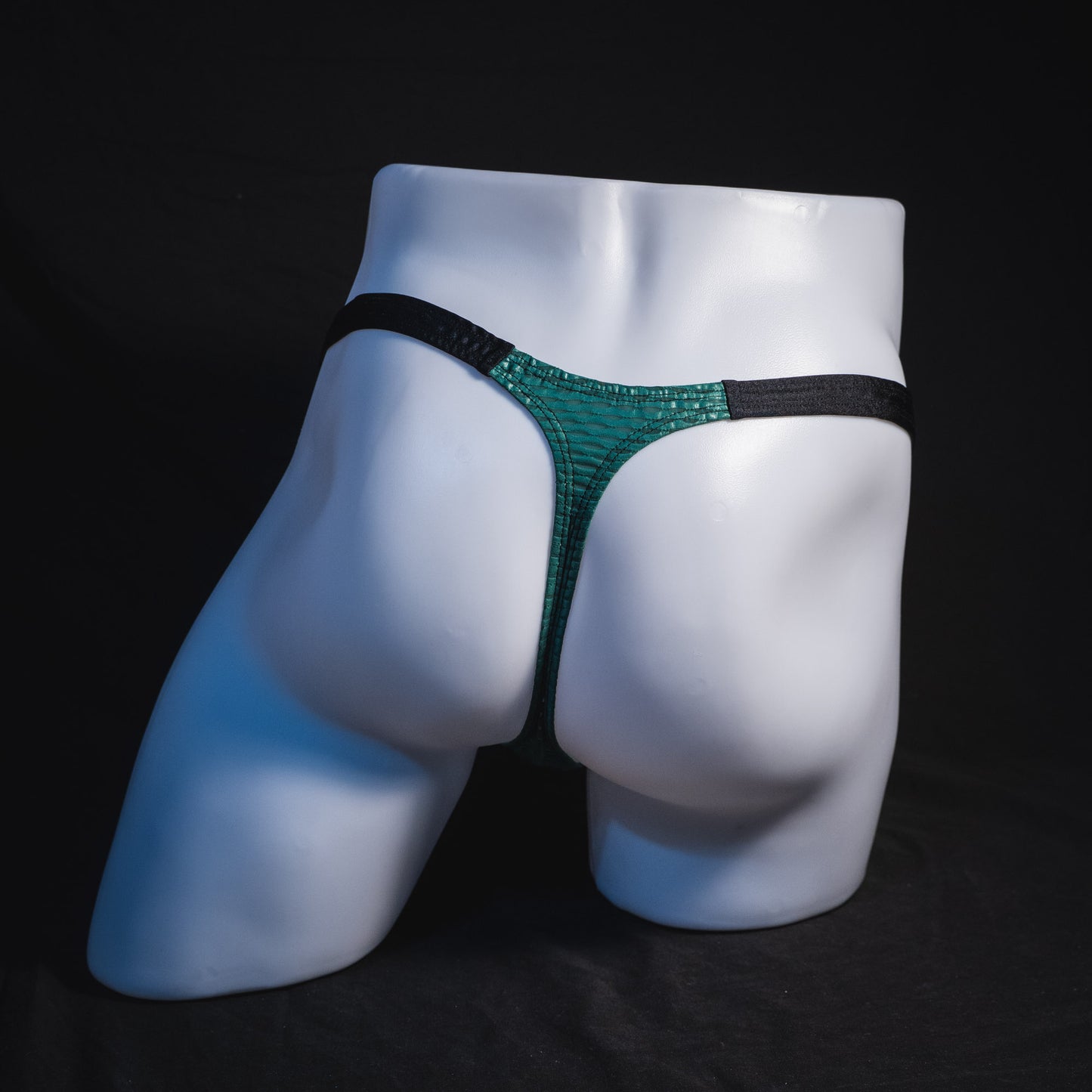 Men's green and black mesh thong underwear, classic cut, full rear view.