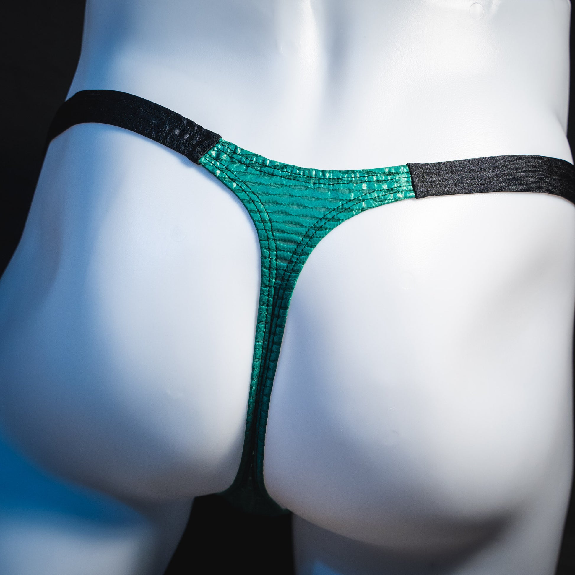 Men's green and black mesh thong underwear, classic cut, rear view.