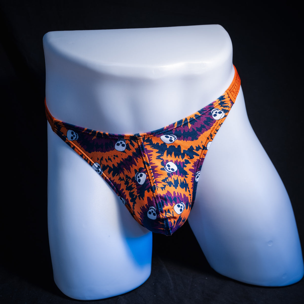 Men's Halloween Tie Dye with skulls thong underwear, classic cut, front view.
