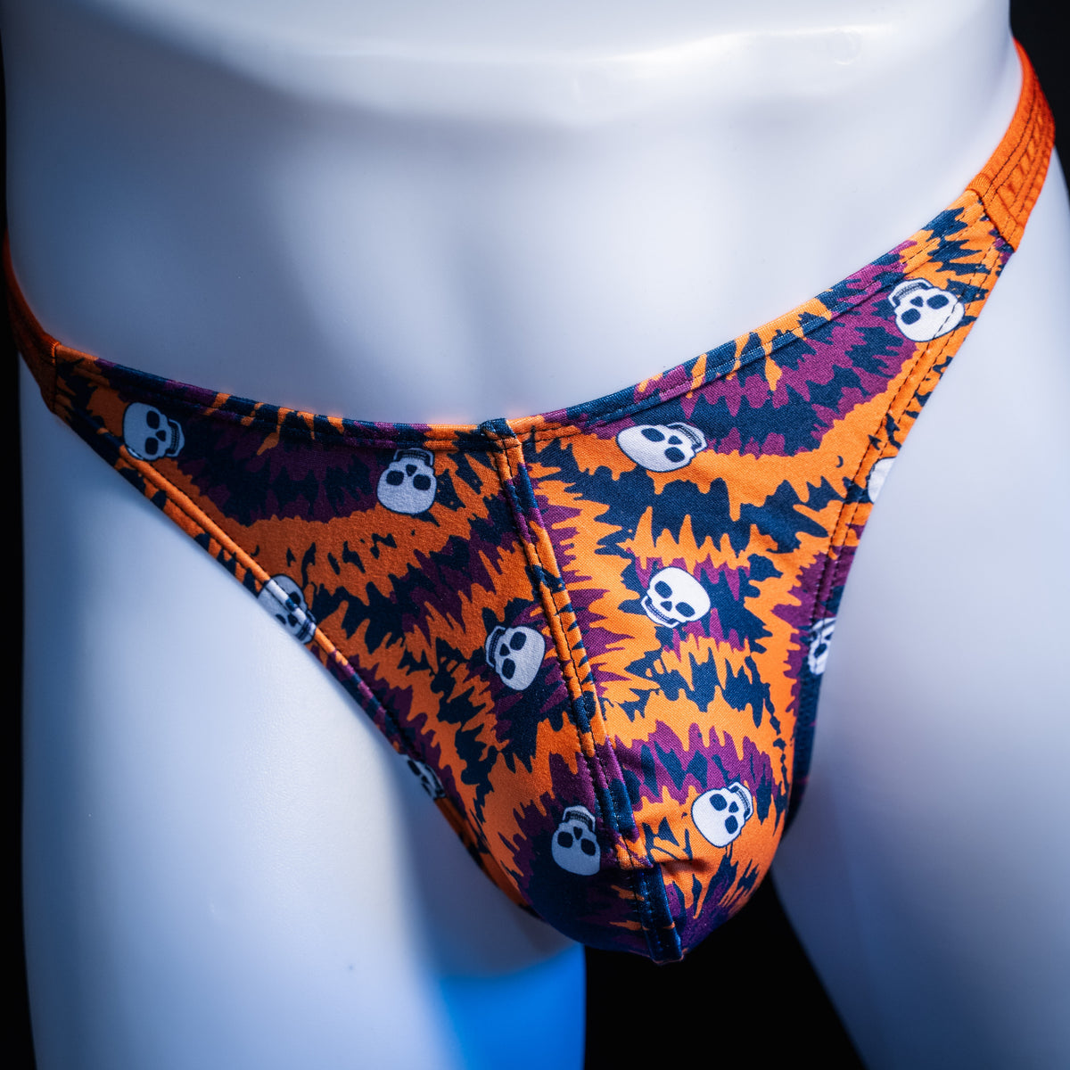 Men's Halloween Tie Dye with skulls thong underwear, classic cut, front view.