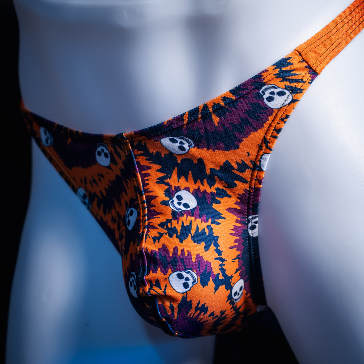 Men's Halloween Tie Dye with skulls thong underwear, classic cut, front view.