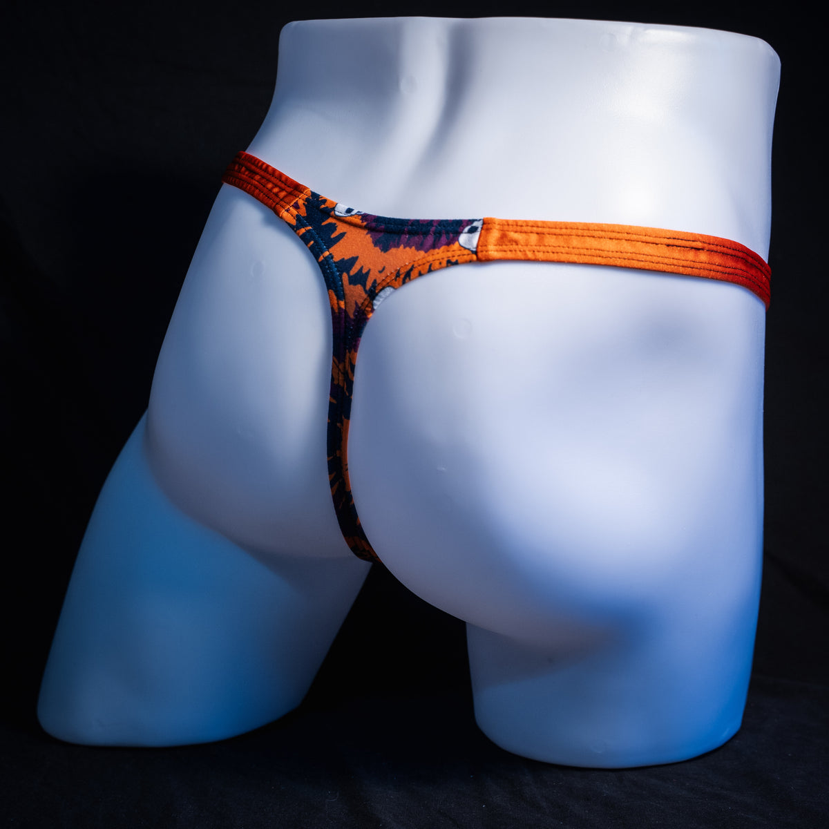 Men's Halloween Tie Dye with skulls thong underwear, classic cut, rear view.