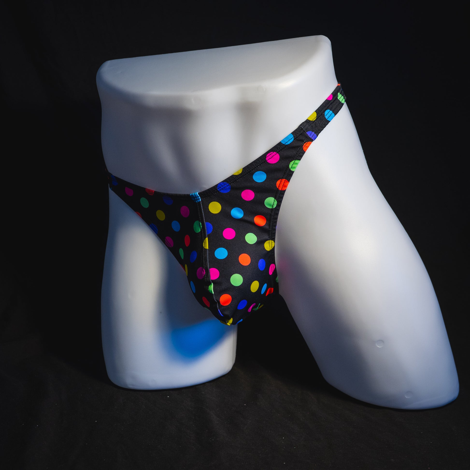 Men's multi colored polka dot thong underwear, classic cut, full angled front view.