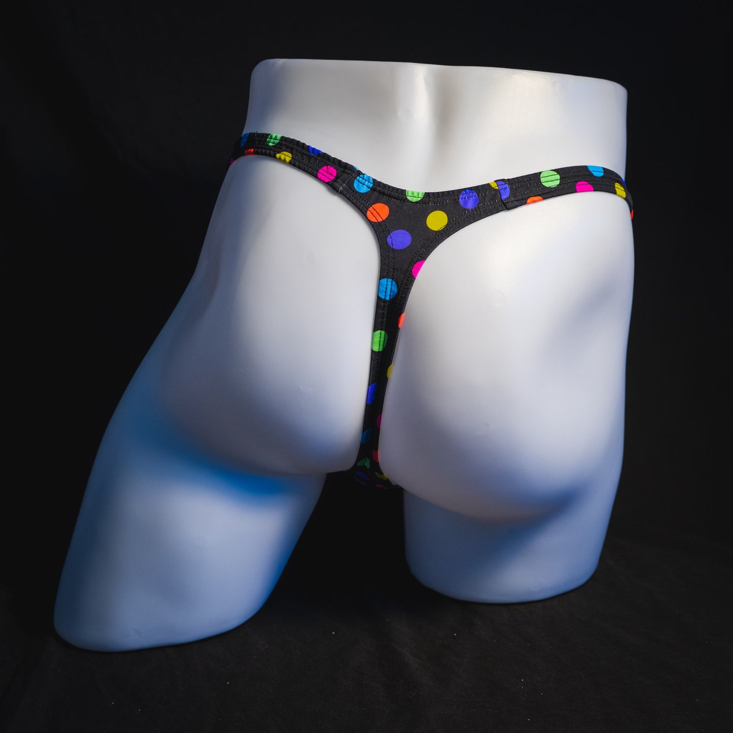 Men's multi colored polka dot thong underwear, classic cut, full rear view.