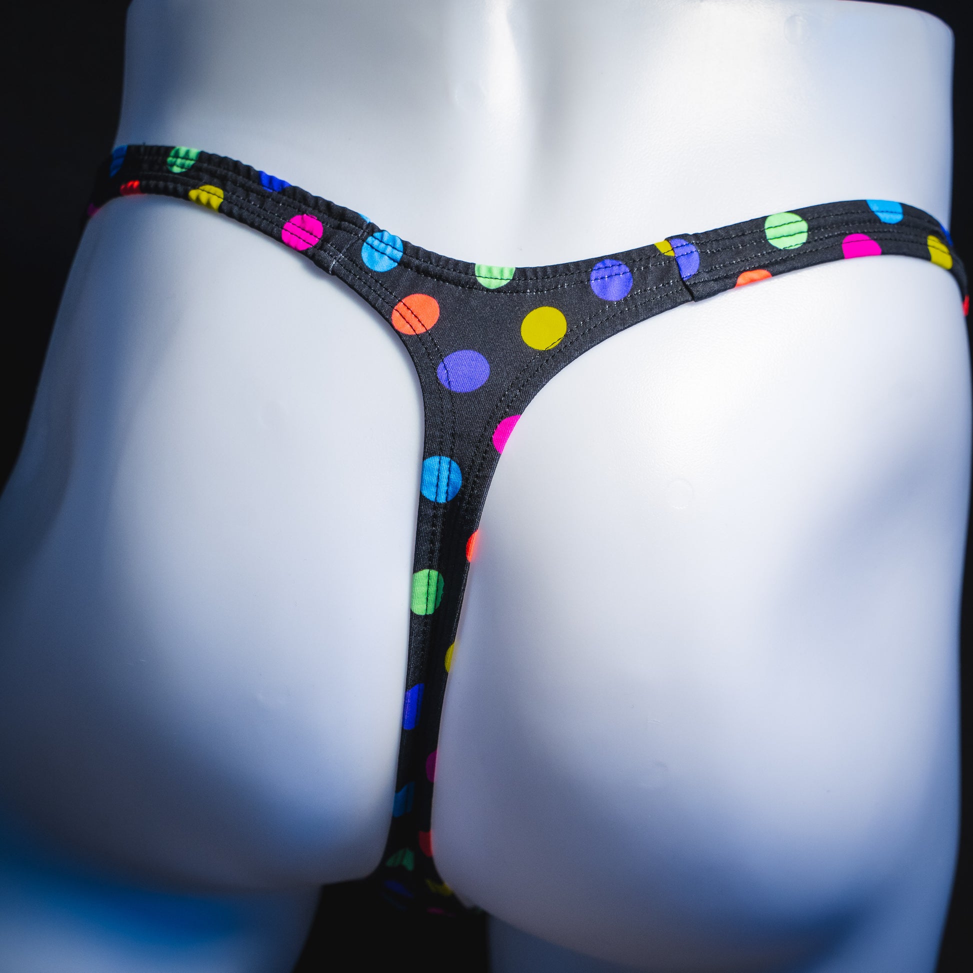 Men's multi colored polka dot thong underwear, classic cut, rear view.