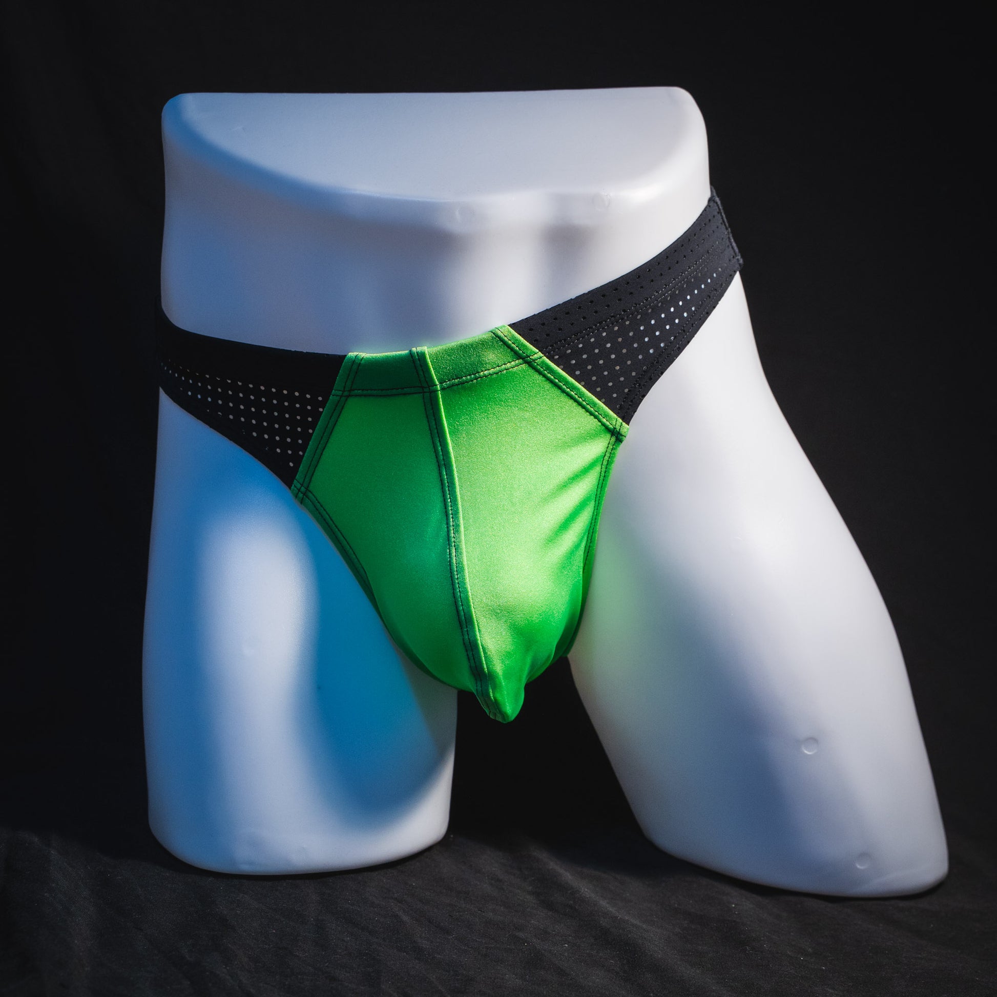 Men's neon green and black mesh athletic thong underwear, full front view.