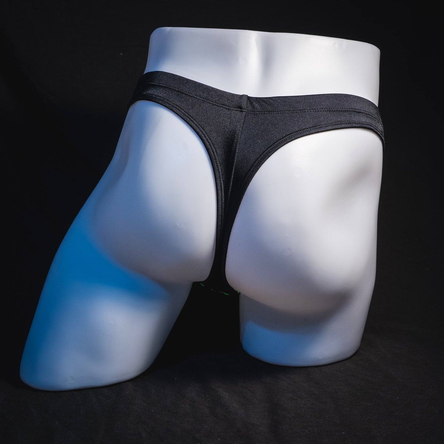 Men's black thong underwear, full rear view.