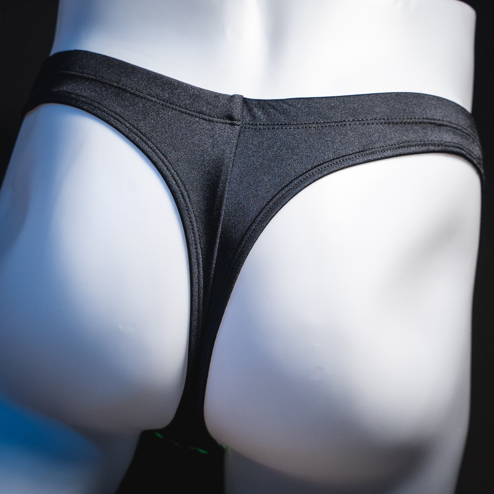 Men's black thong underwear, rear view.