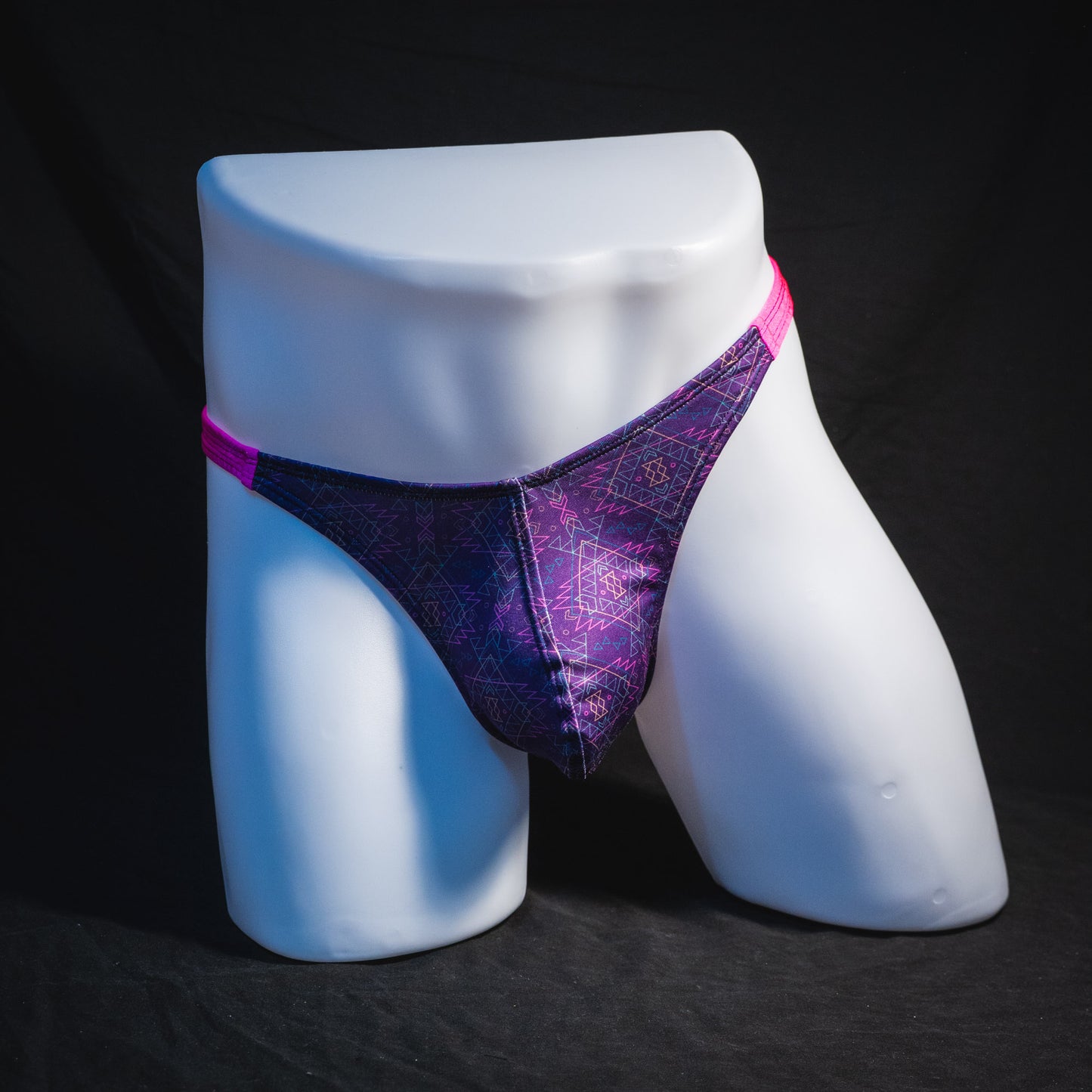 Men's pink and purple thong underwear, classic cut, front view.