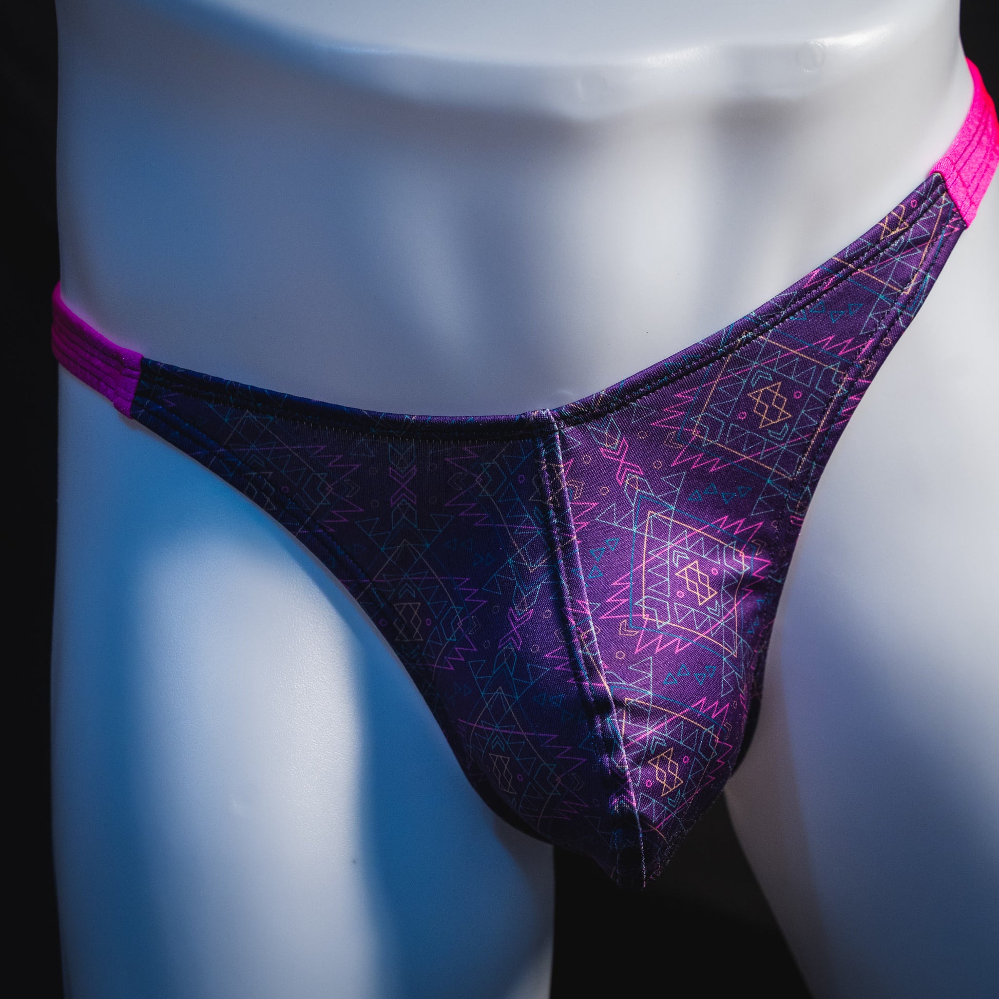 Men's pink and purple thong underwear, classic cut, front view.
