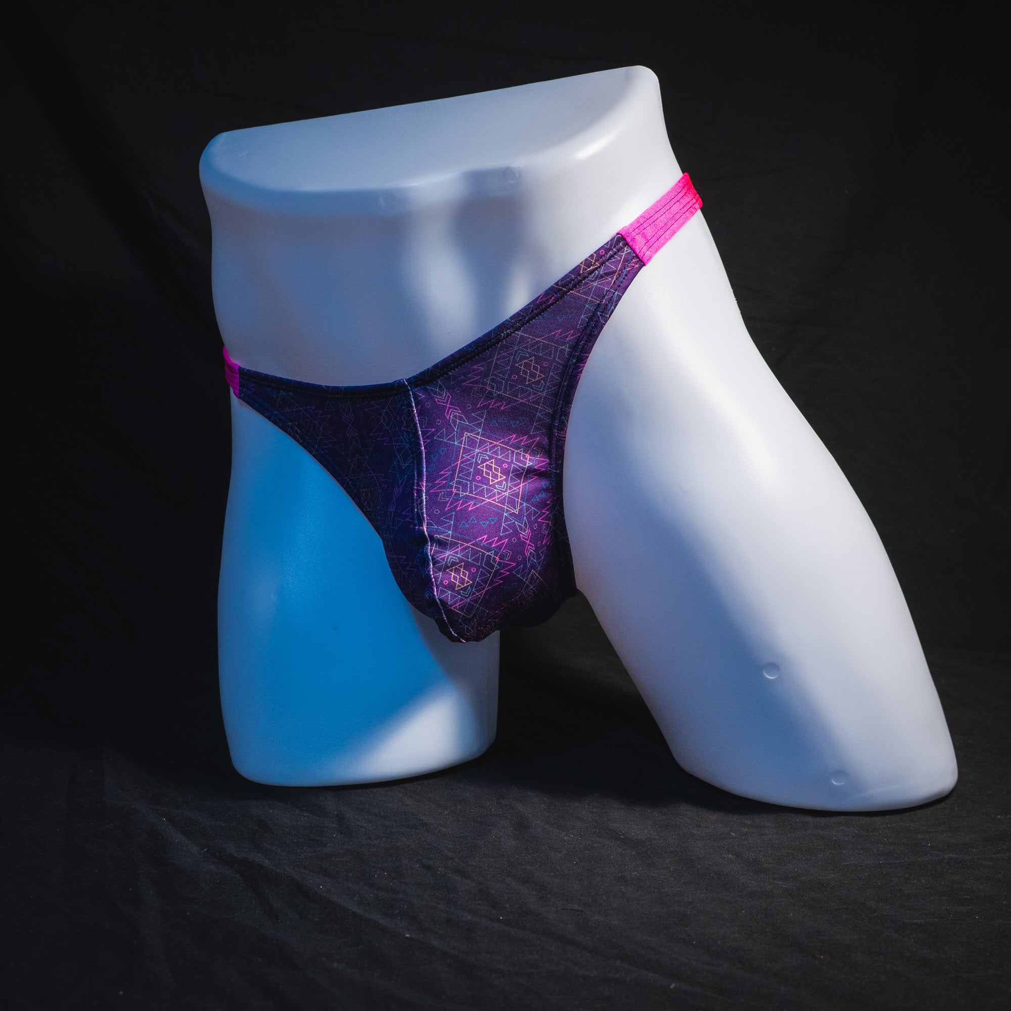 Men's pink and purple thong underwear, classic cut, full angled front view.