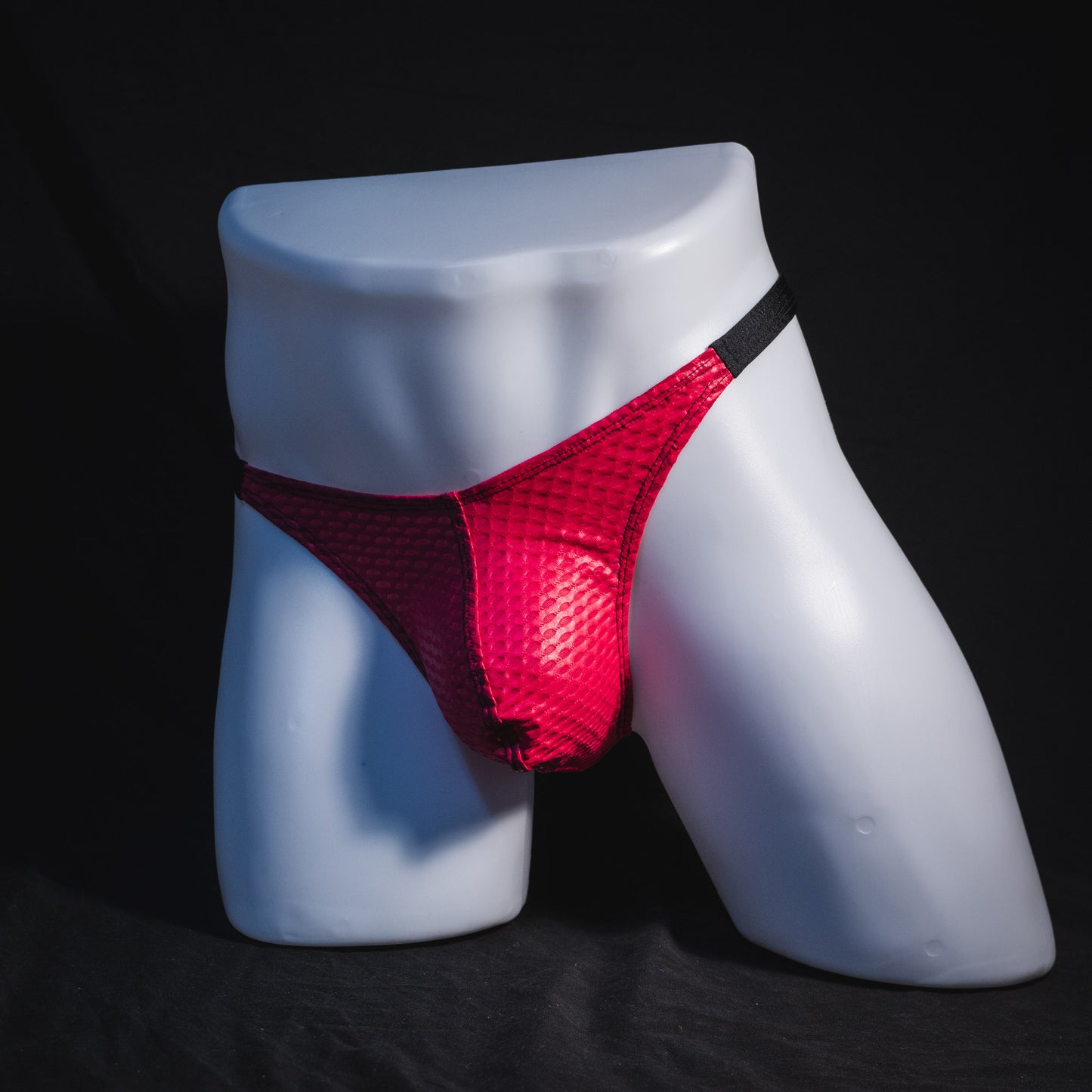 Men's pink athletic mesh thong underwear, classic cut, Full angled front view.