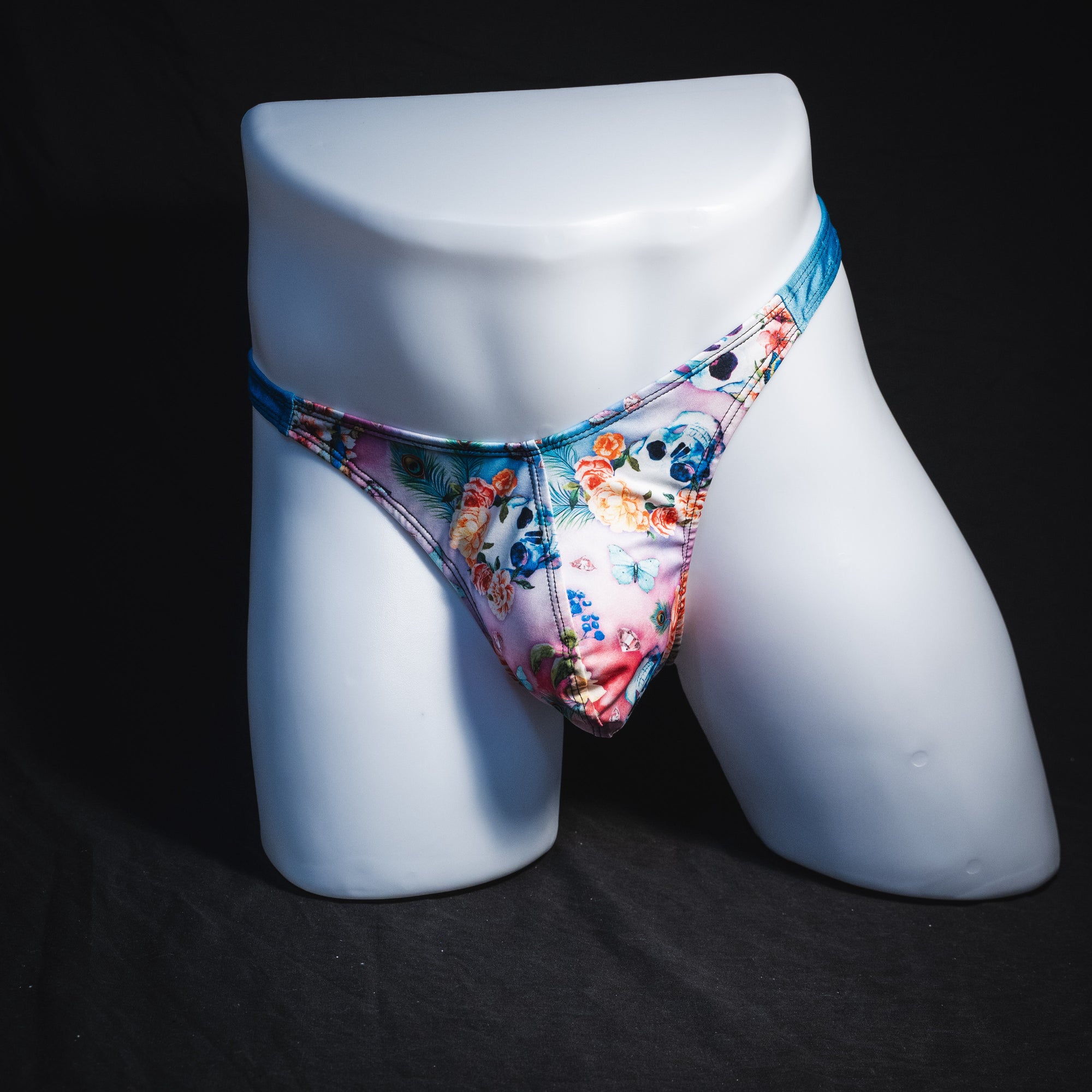 Men's pink floral with skulls and blue straps thong underwear, classic cut, Full front view