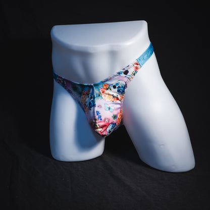 Men's pink floral with skulls and blue straps thong underwear, classic cut, Full angled front view
