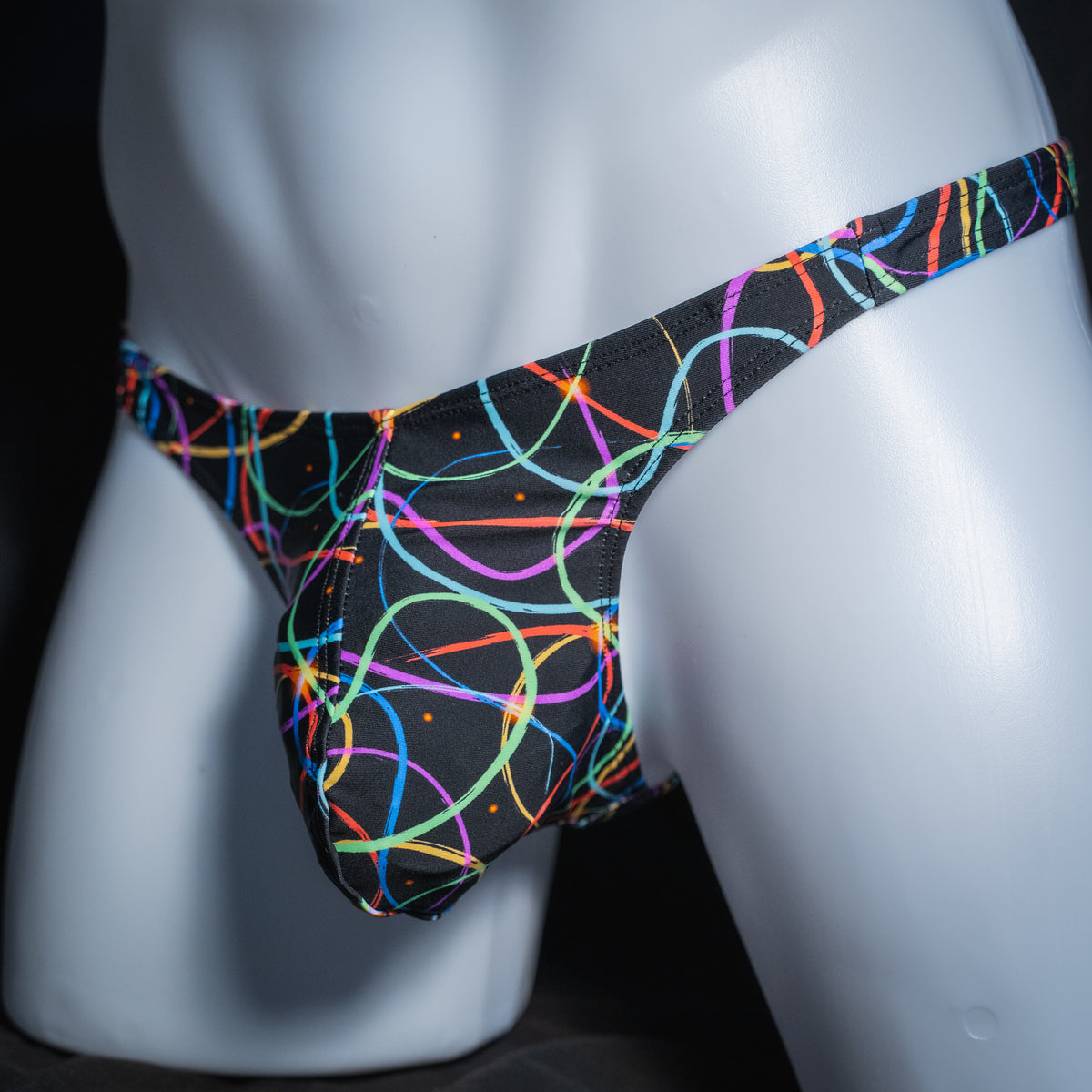 Men's colorful lines thong, classic cut, angled front view.