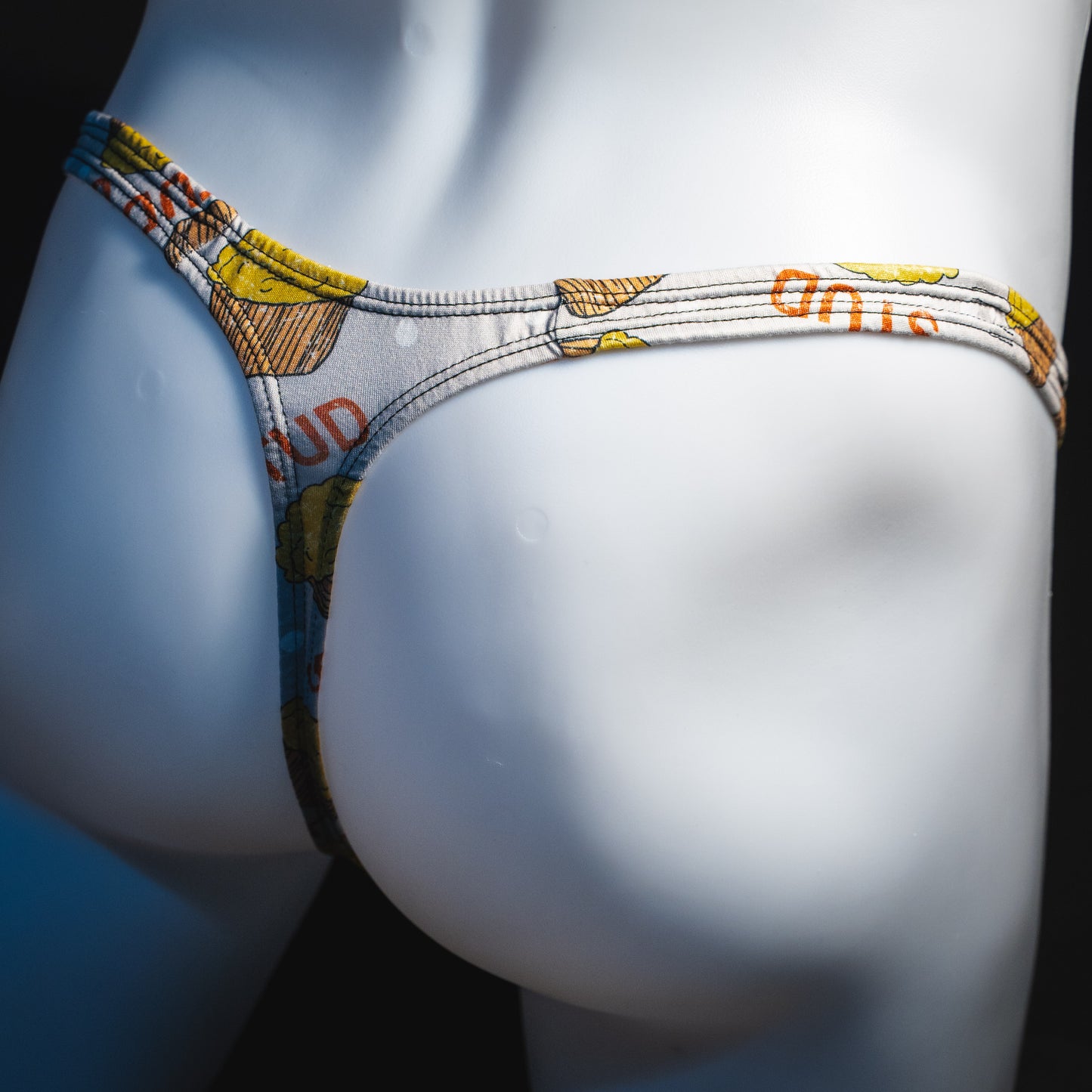 Men's stud muffin thong underwear, classic cut, angled rear view.
