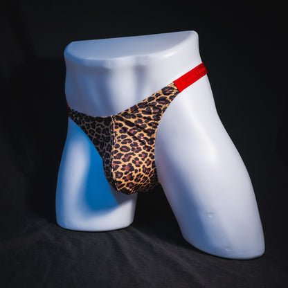 Men's cheetah print thong with red waistband, classic cut, full front angled view.
