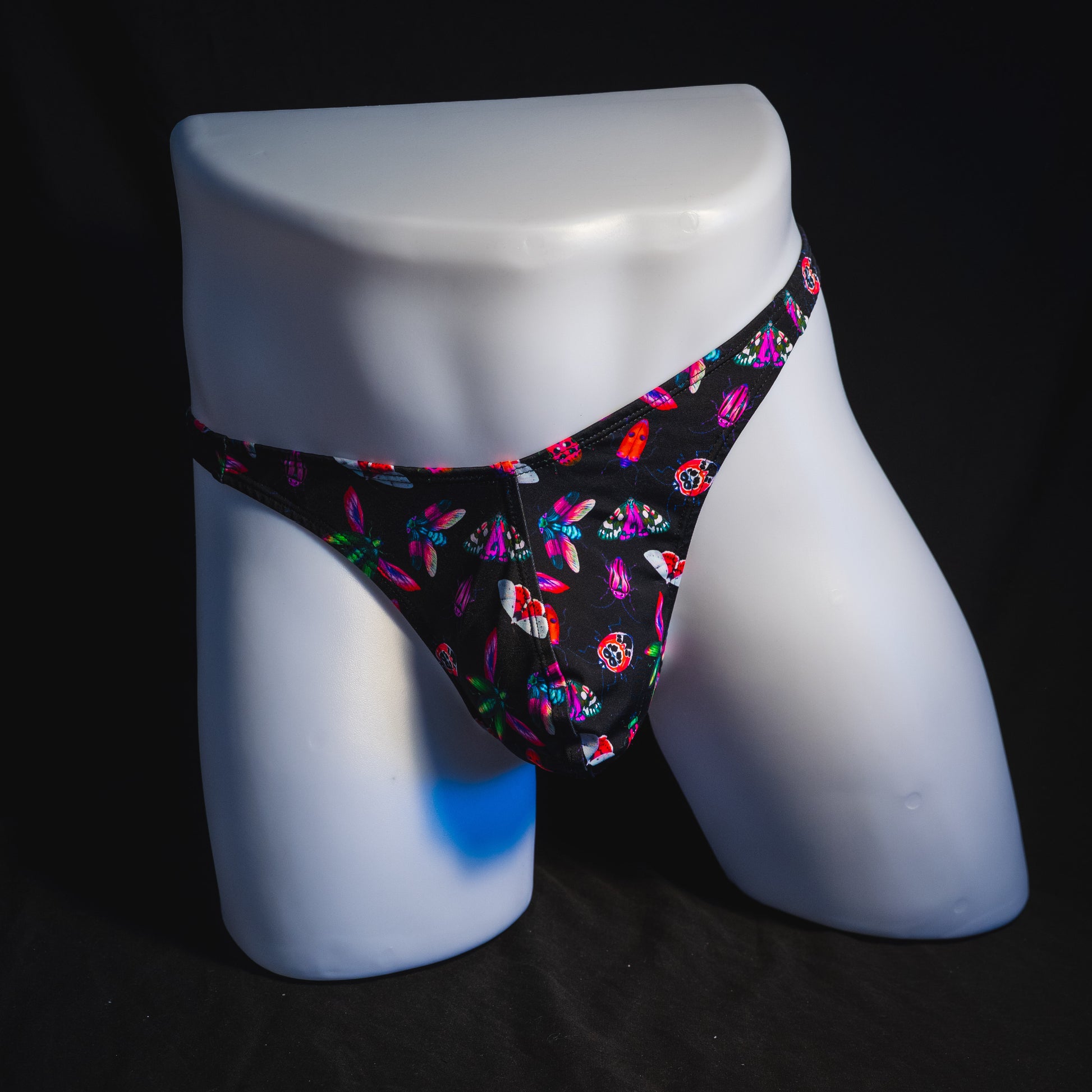 Men's black with pink insects thong underwear, Classic cut, full front view.