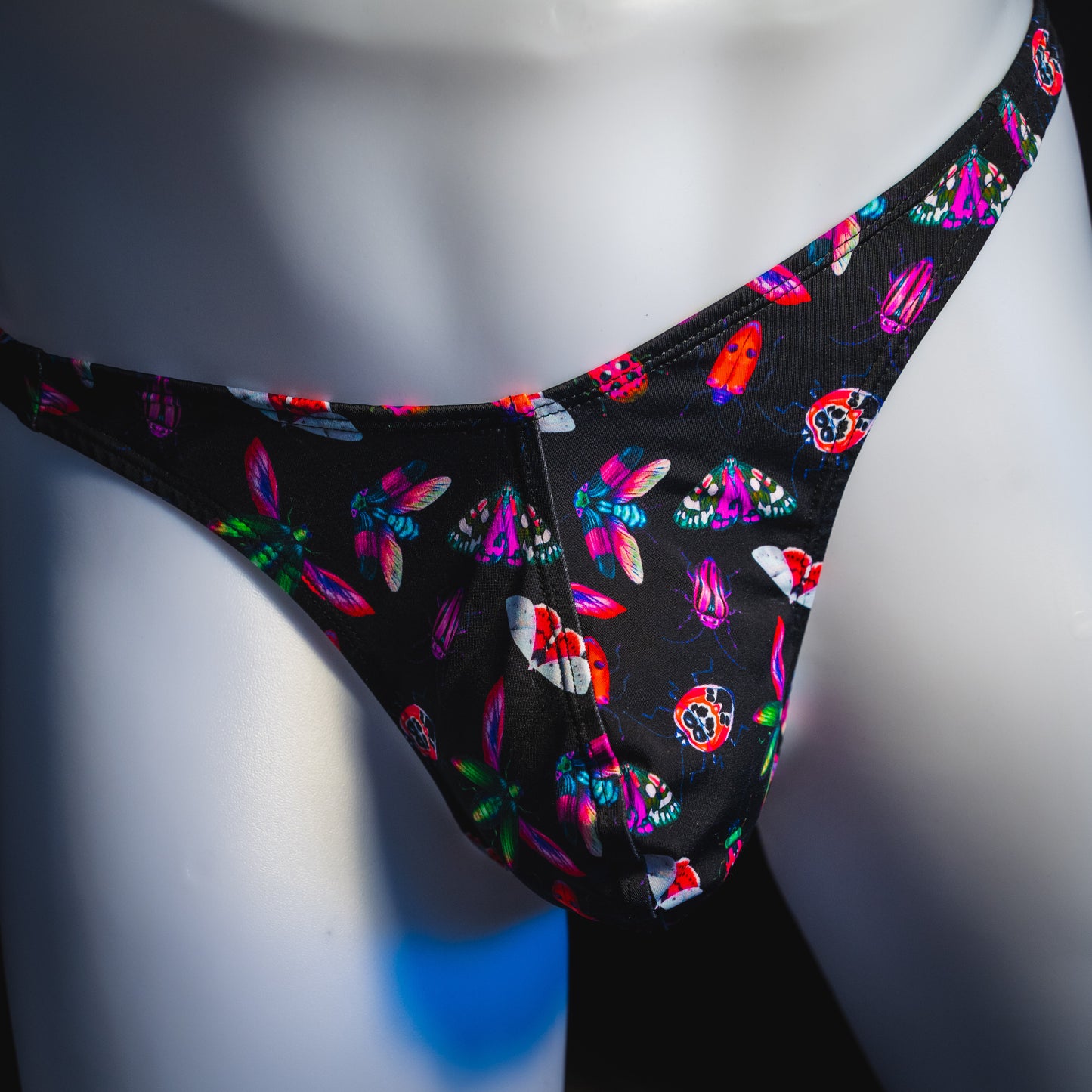 Men's black with pink insects thong underwear, Classic cut, front view.