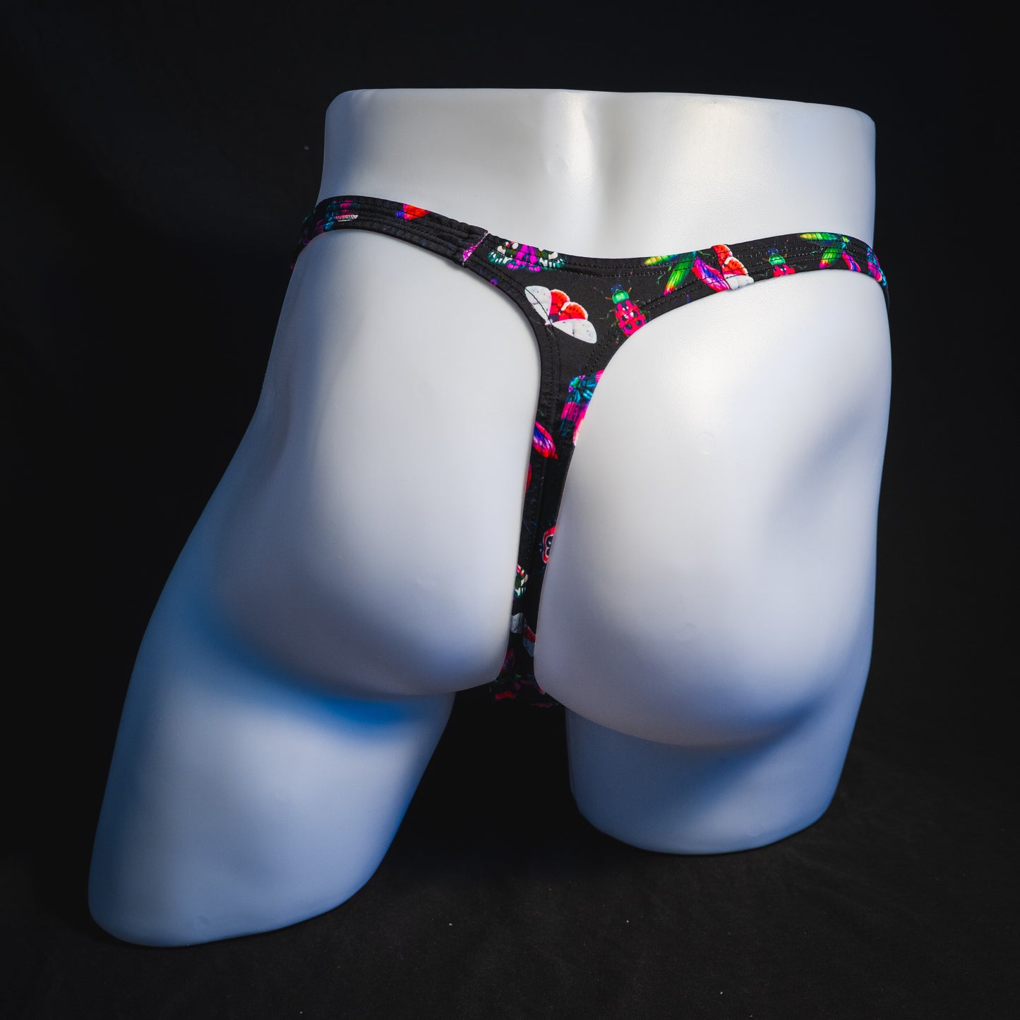 Men's black with pink insects thong underwear, Classic cut, full rear view.