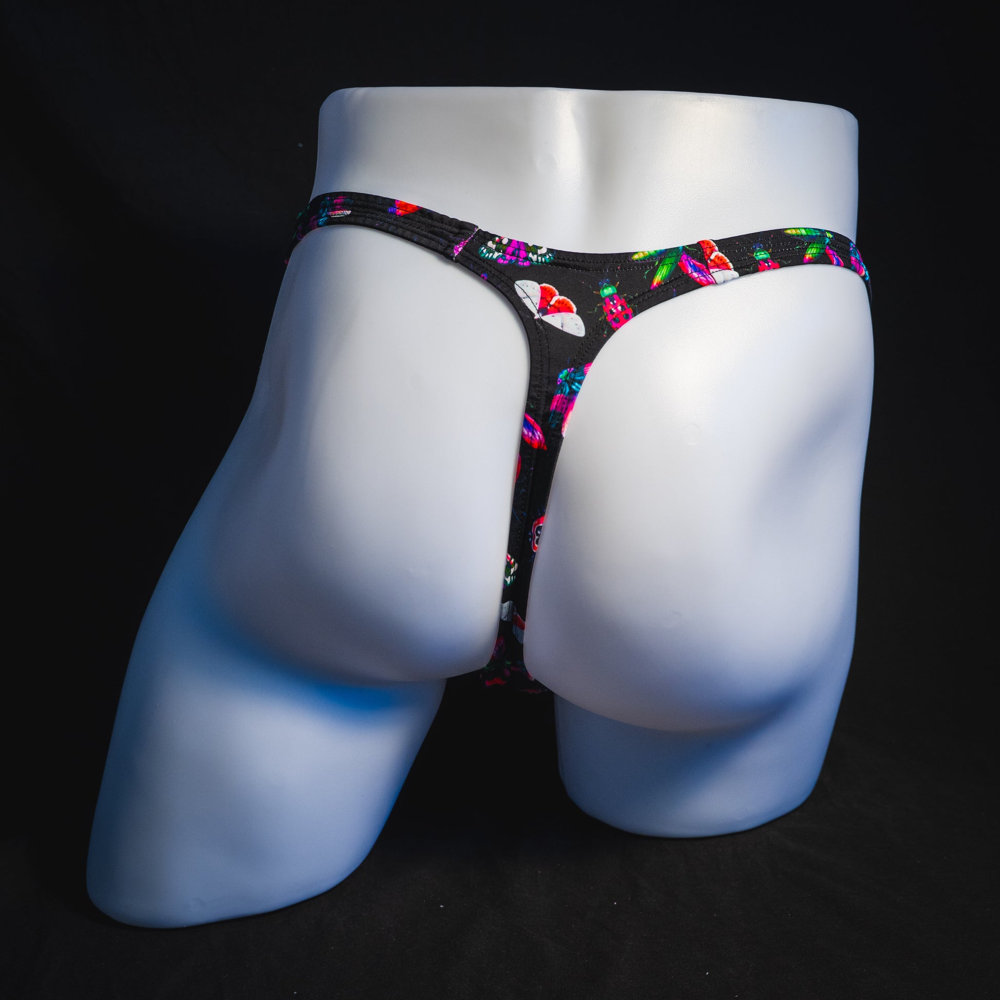 Men's black with pink insects thong underwear, Classic cut, full rear view.