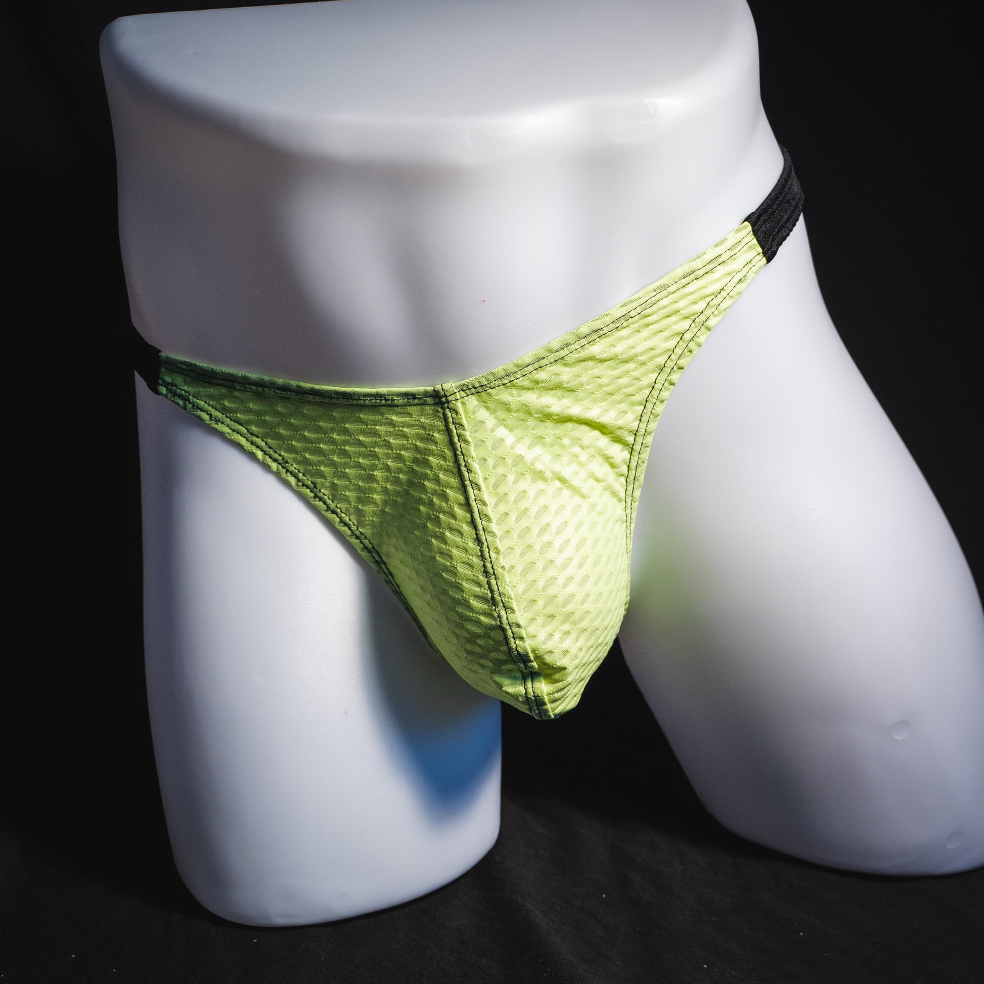 Men's lime green and black athletic mesh thong underwear, classic cut, full front view.