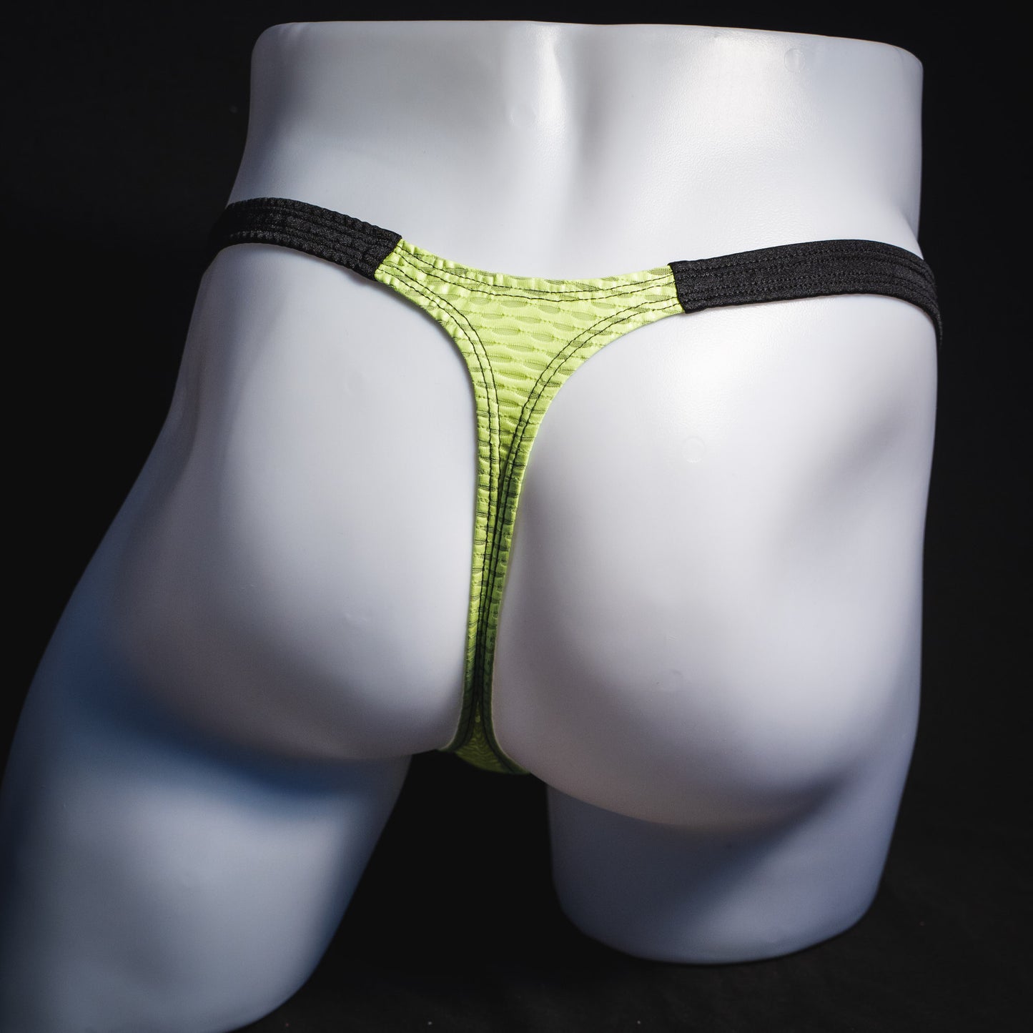 Men's lime green and black athletic mesh thong underwear, classic cut, full rear view.