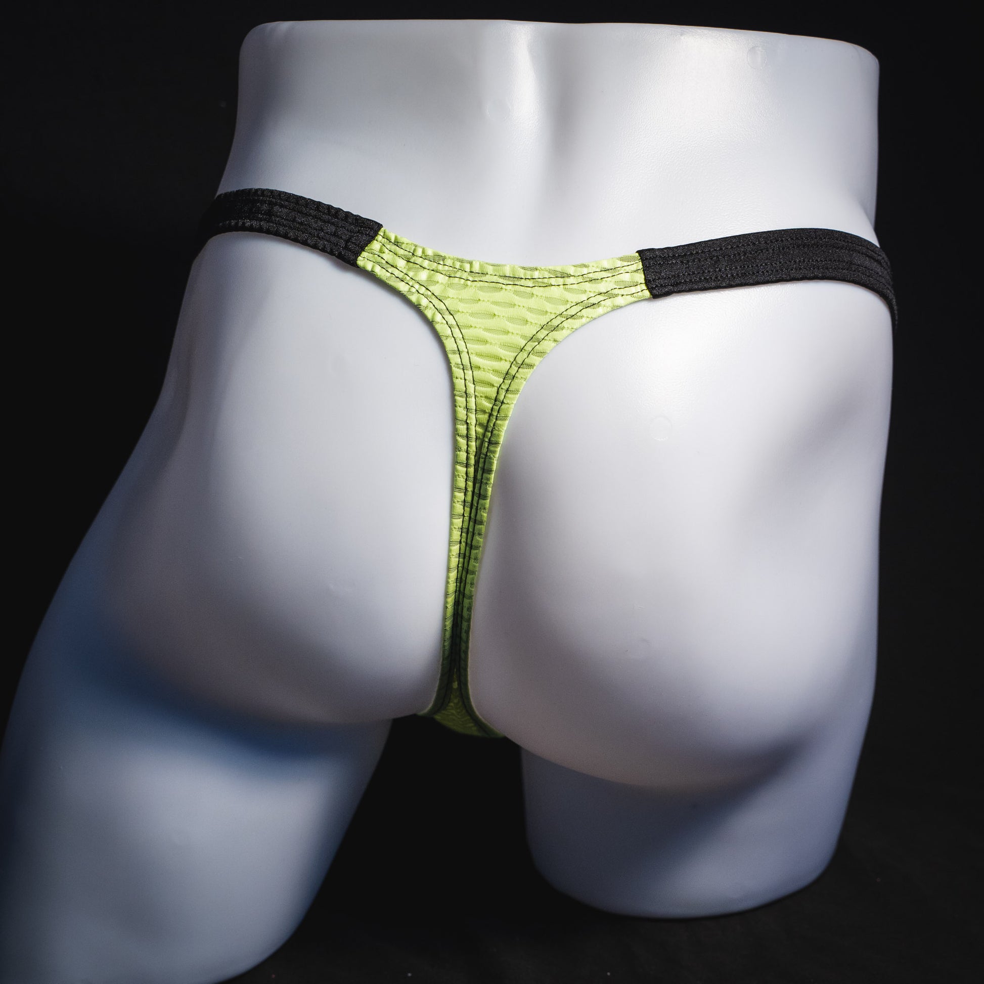 Men's lime green and black athletic mesh thong underwear, classic cut, full rear view.