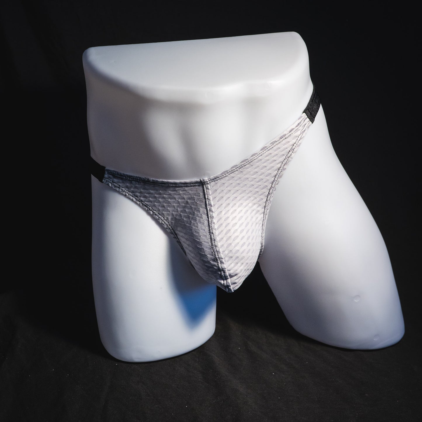 Men's ash white and black athletic mesh thong underwear, classic cut, front view.